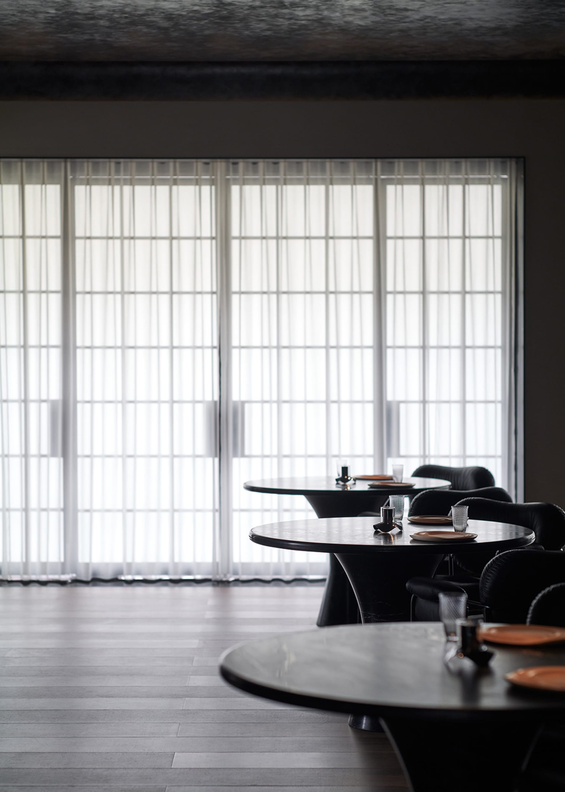A clean and well-organized restaurant with multiple dining tables and chairs, ready for customers