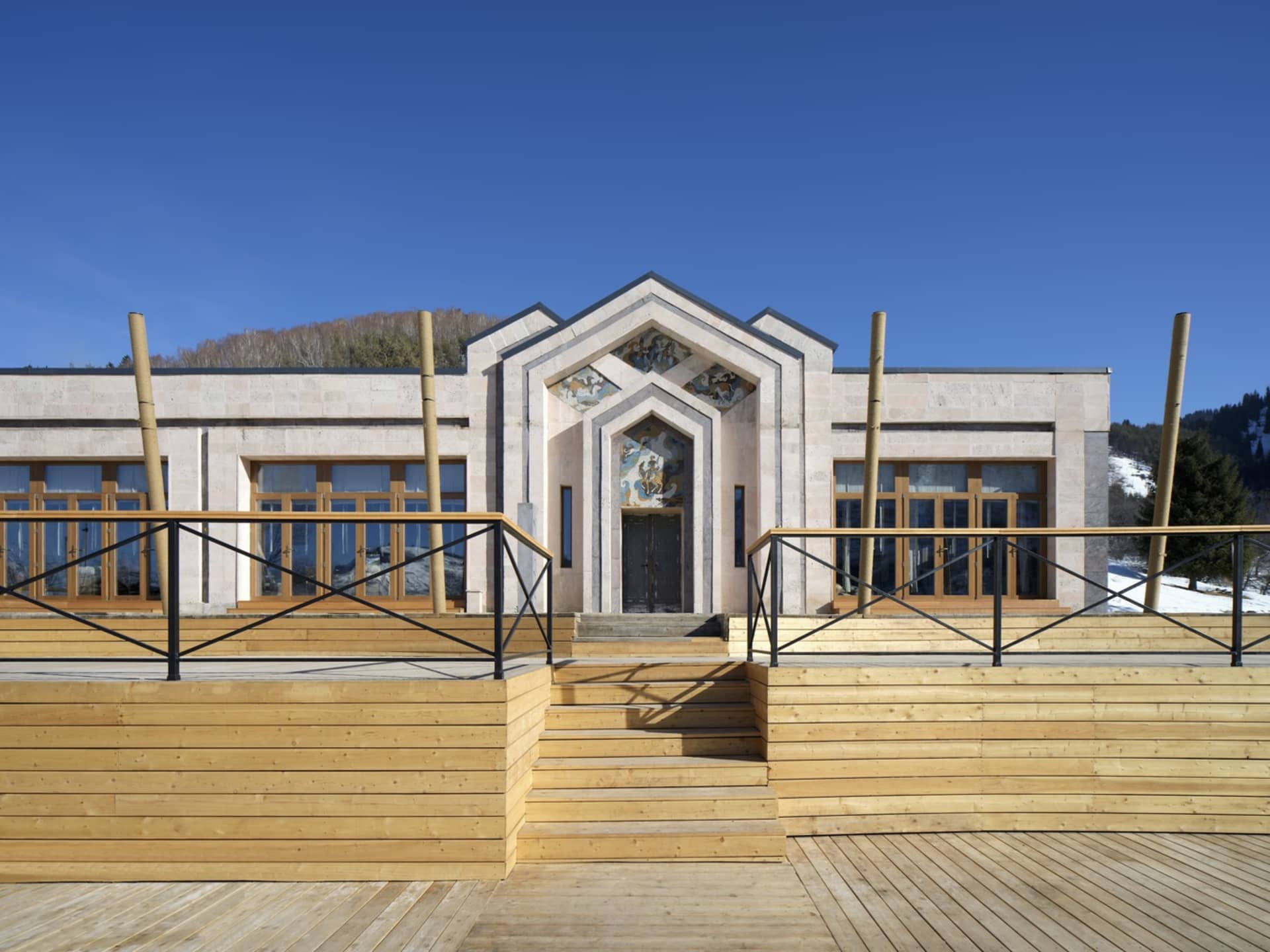 A classic building with a stone exterior and a wooden staircase, creating a harmonious blend of materials and textures