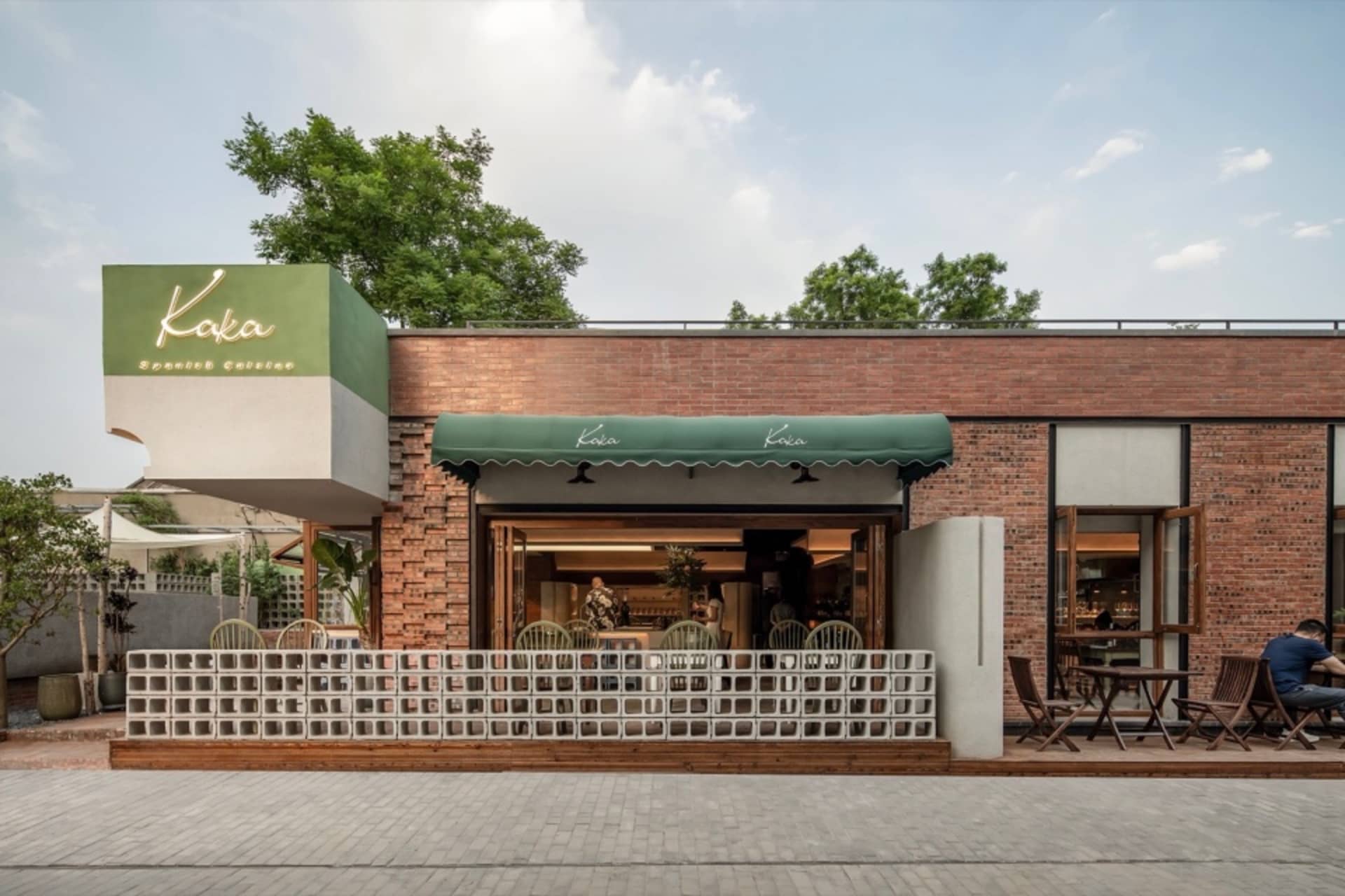 An inviting outdoor restaurant patio with multiple tables and chairs, some with cushions, set in a pleasant outdoor setting