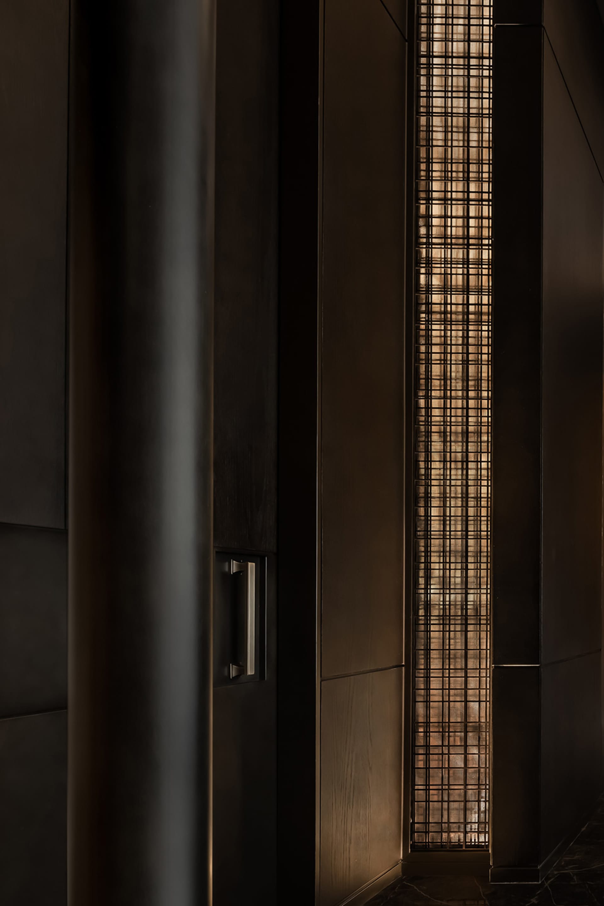 Wooden hallway with a metal grate covering a window, two doors on either side, and a cozy atmosphere