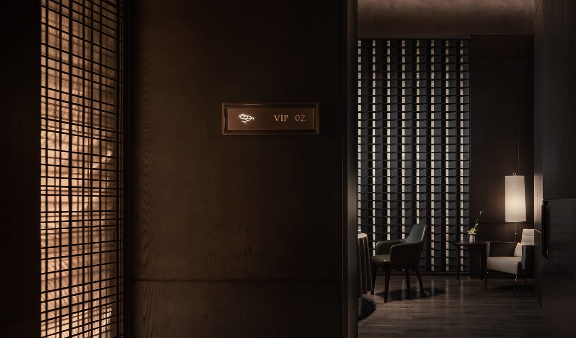 Modern room with a wooden floor, two chairs, and a sign on the wall