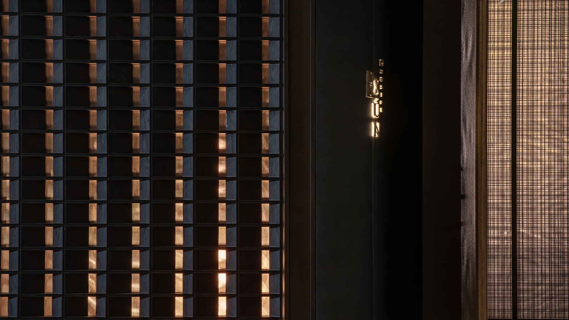 A dimly lit room with two doorways, one on the left and one on the right, creating a sense of mystery