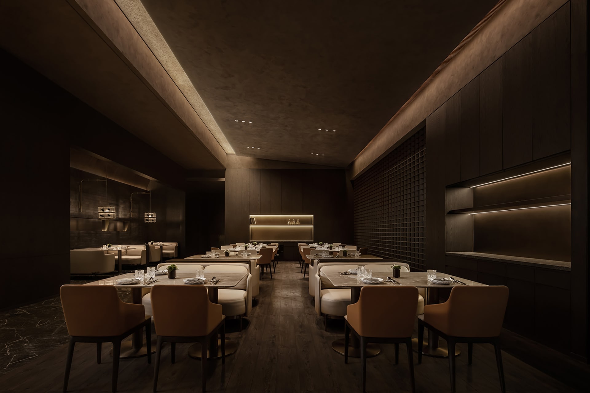 Elegant restaurant interior with wooden floors, white tablecloths, and comfortable seating areas