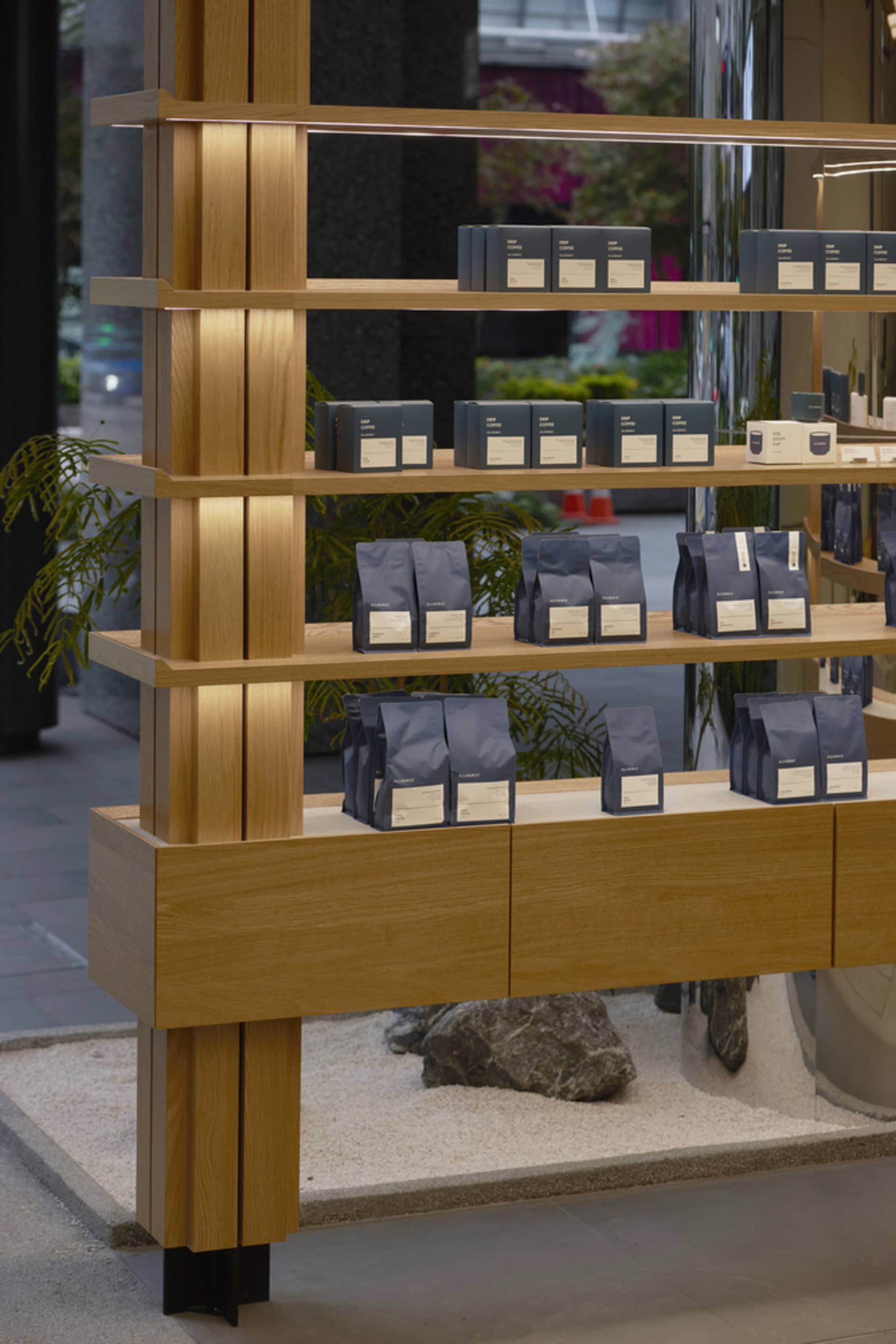 A store display of coffee beans on wooden shelves, arranged for customer exploration and purchase