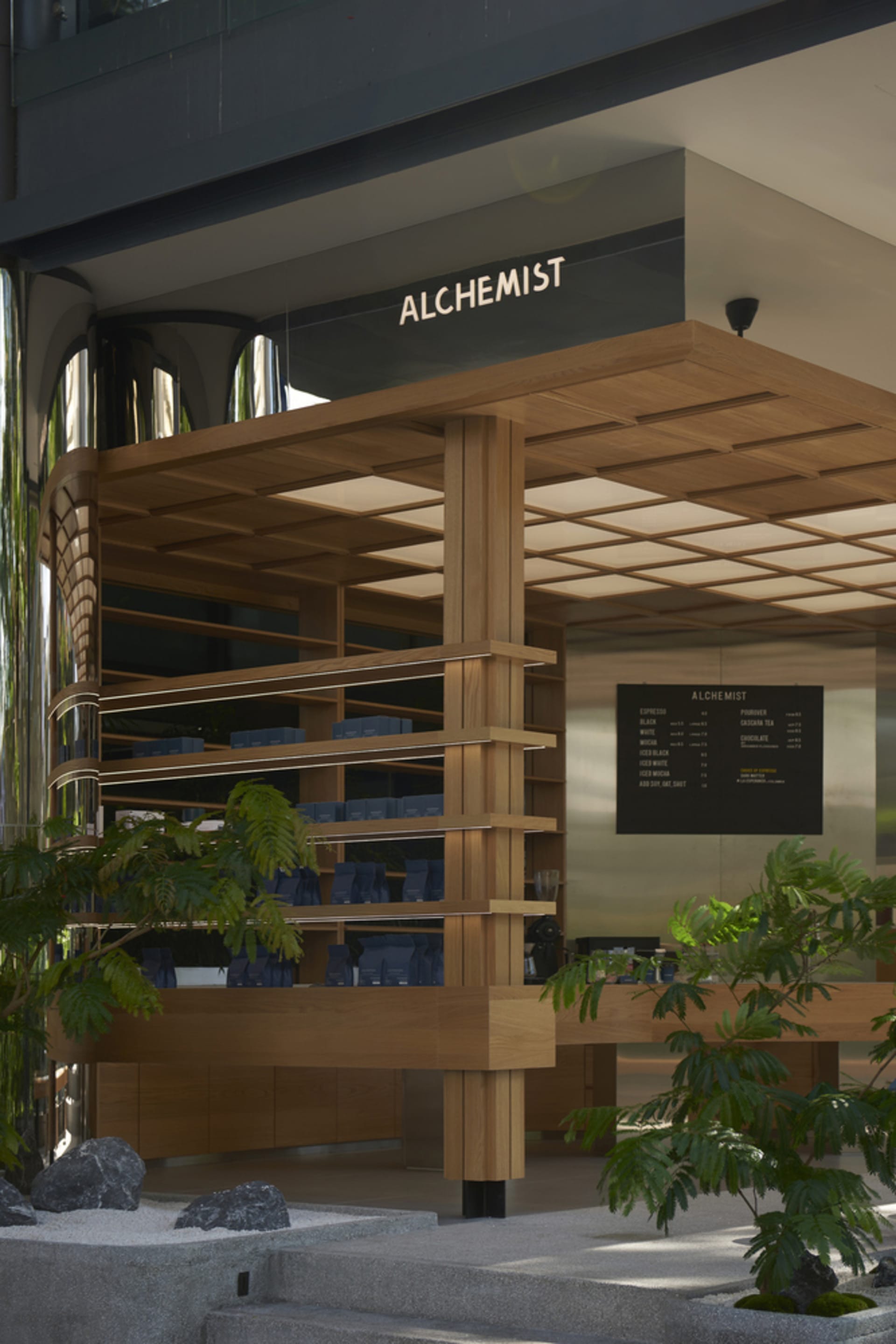 A well-organized retail space with wooden design, featuring bottles and cups on display, creating a warm and inviting atmosphere