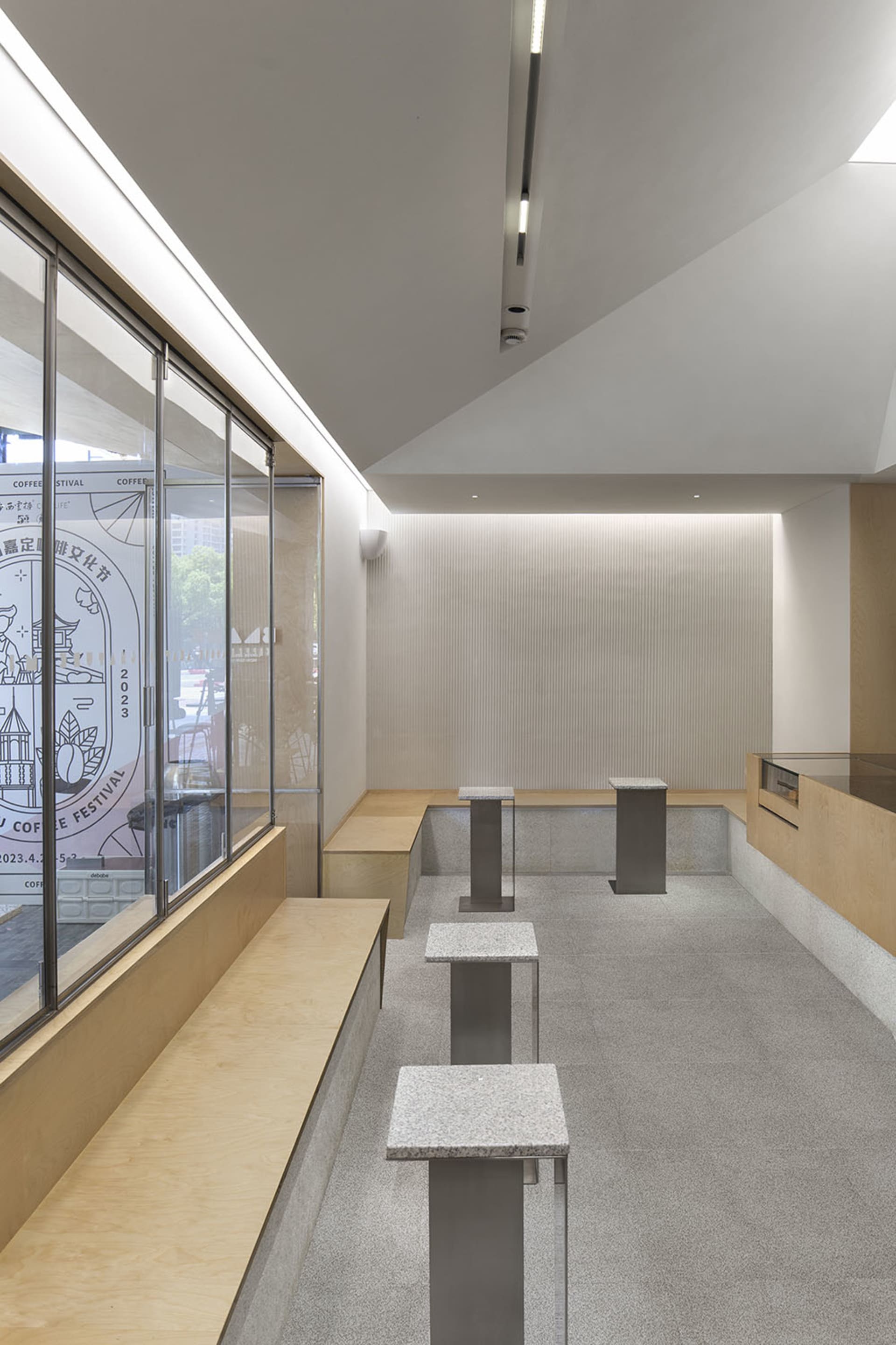 Modern restaurant interior with white walls, natural light, and seating areas