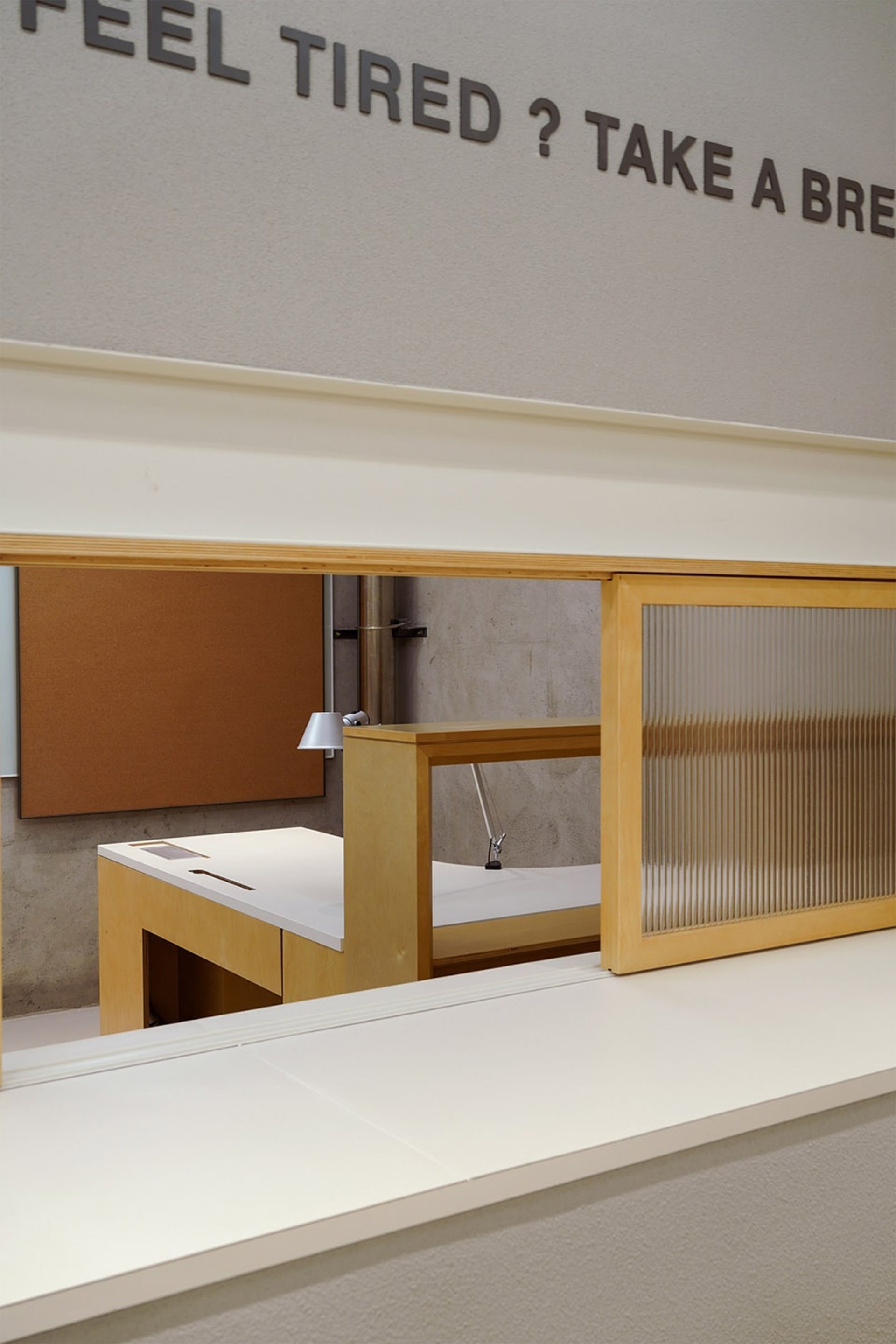 An organized office space with a desk, two chairs, a keyboard, mouse, and a book, suitable for work or study