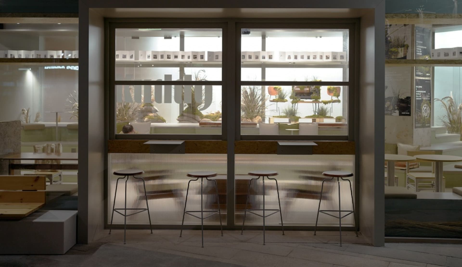 Bright dining space with natural light, multiple dining tables, chairs, and potted plants