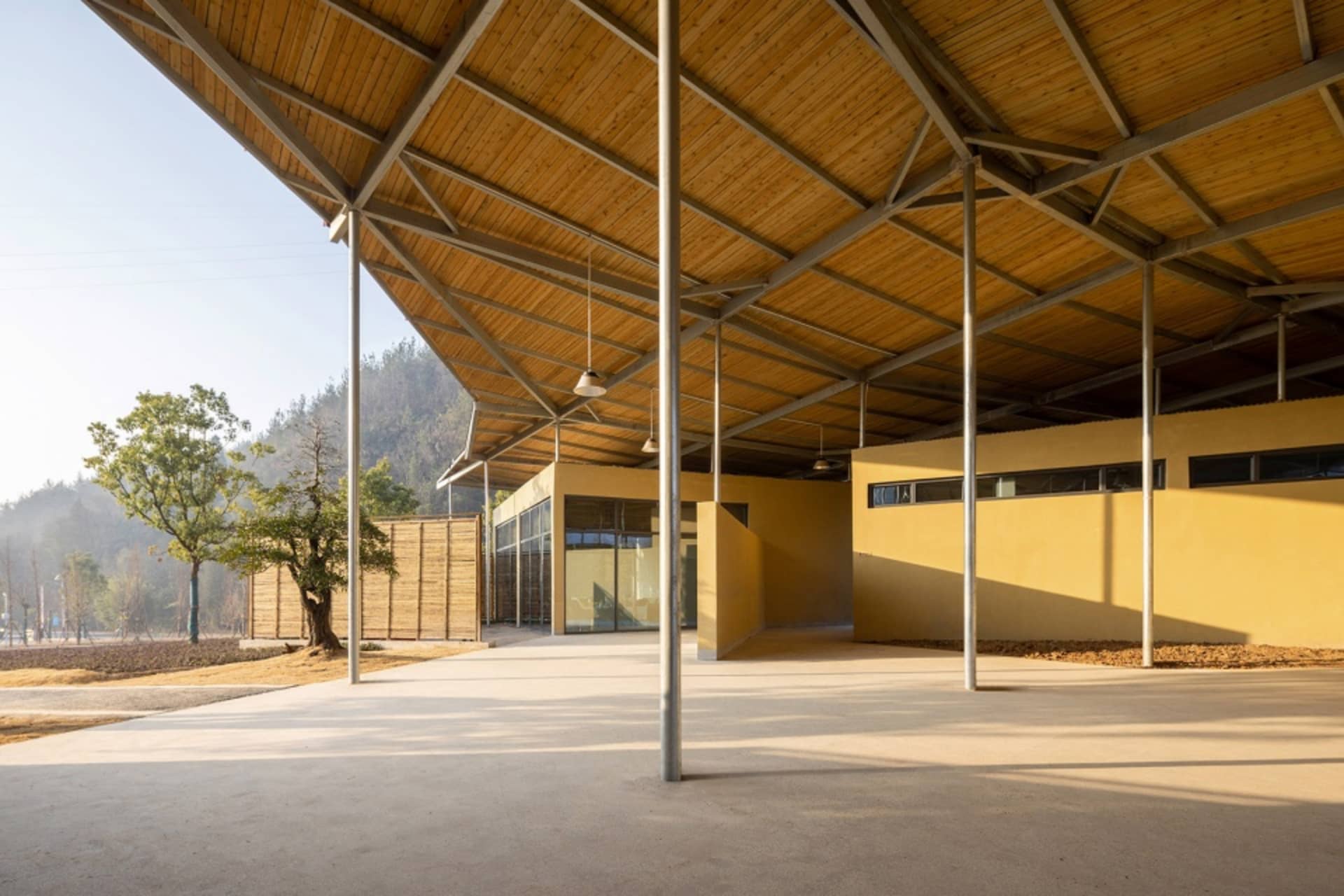 Open public space with a large wooden structure, metal accents, and natural light from windows