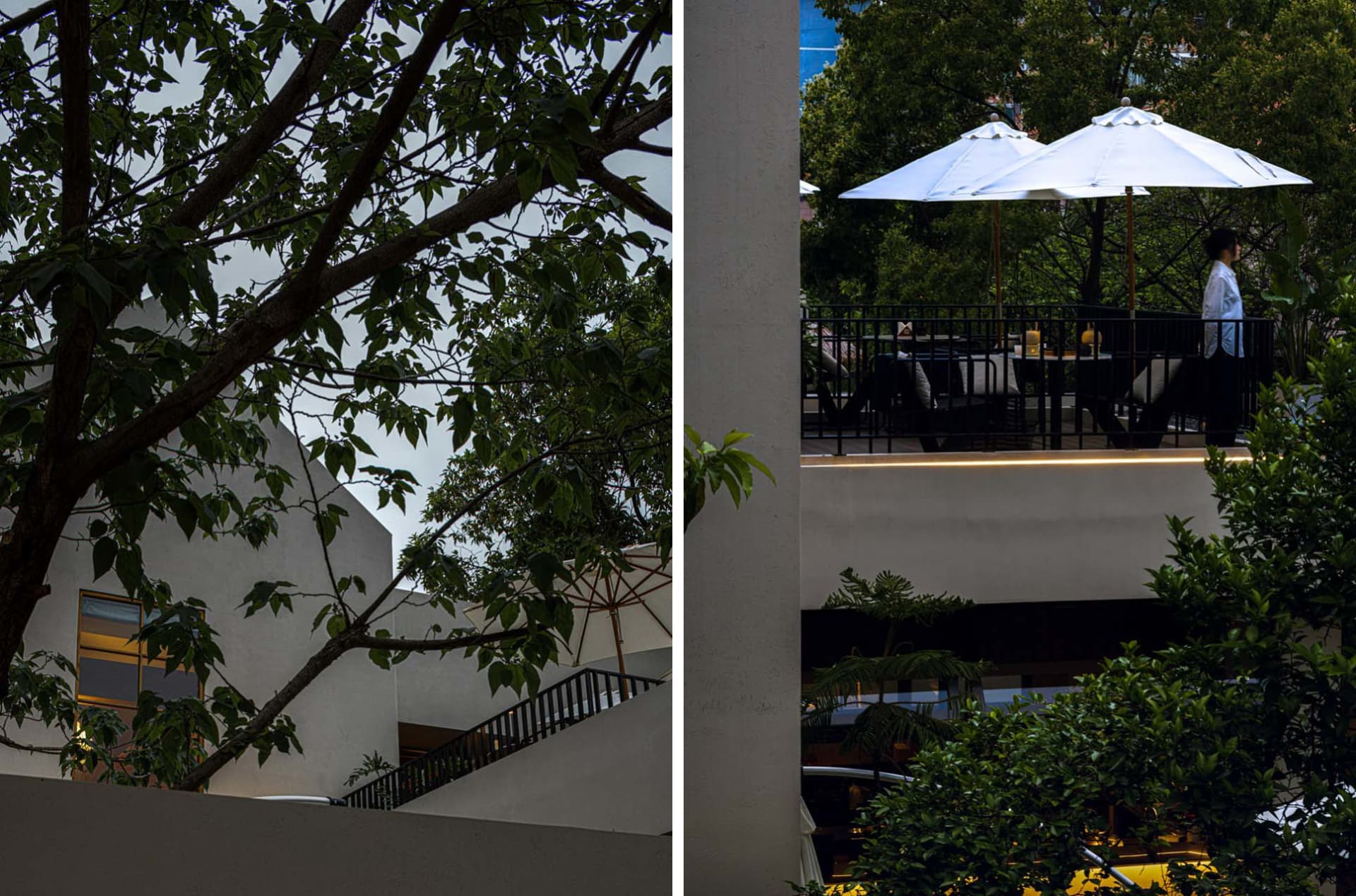A restaurant or hotel lobby with chairs, a dining table, and umbrellas providing shade and a comfortable atmosphere