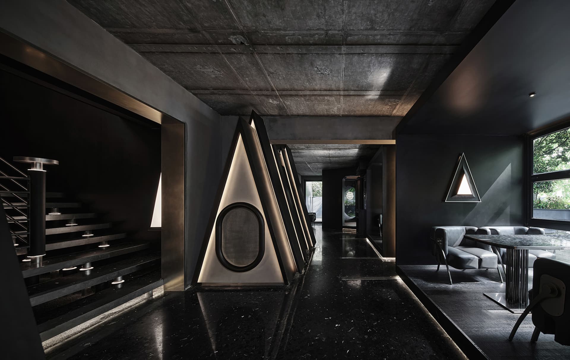 A dark and mysterious office space with a long hallway featuring multiple rooms on either side, chairs placed throughout, and a somber atmosphere