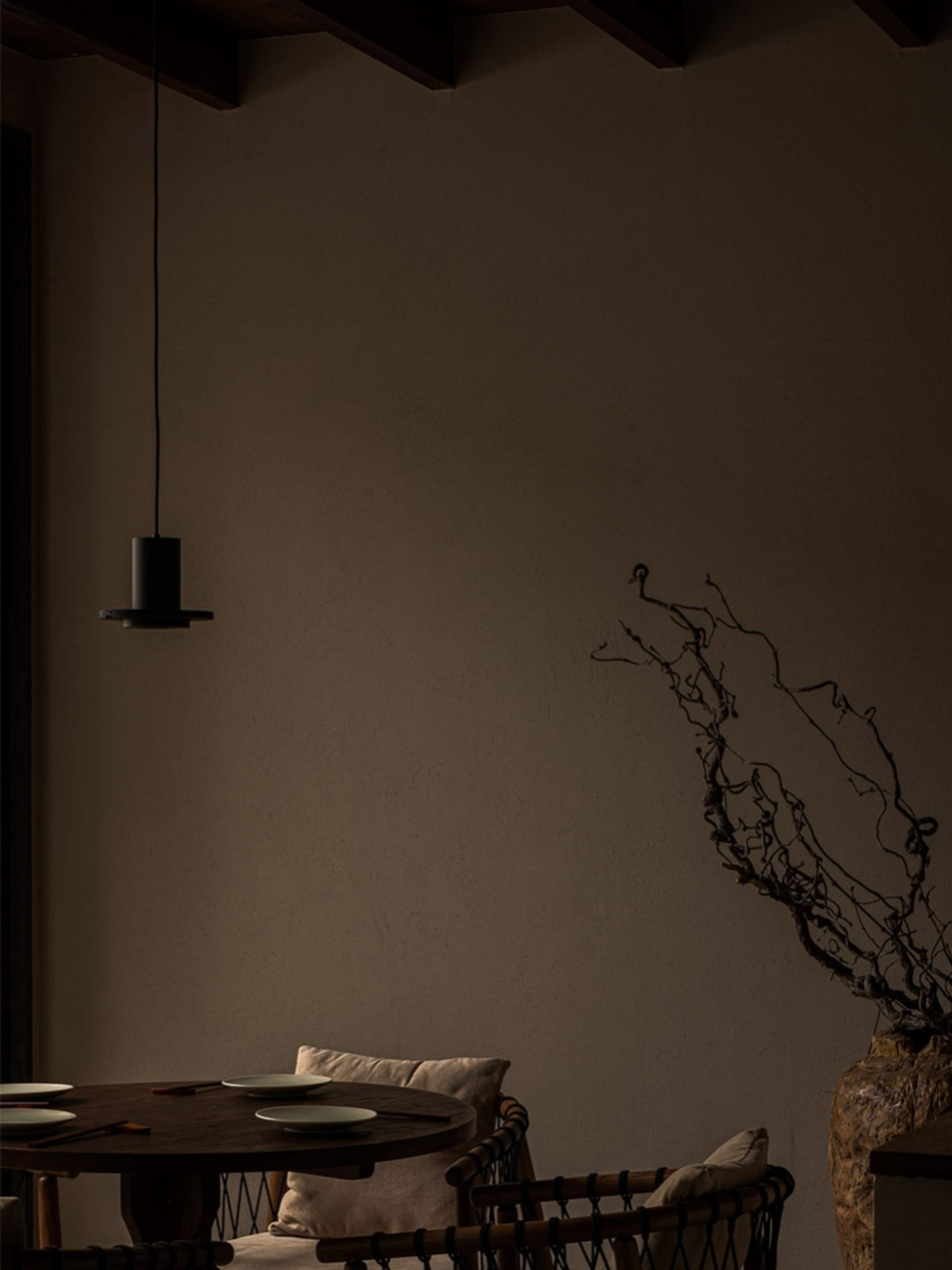 A cozy living room with a wooden dining table surrounded by chairs, creating a warm and inviting atmosphere