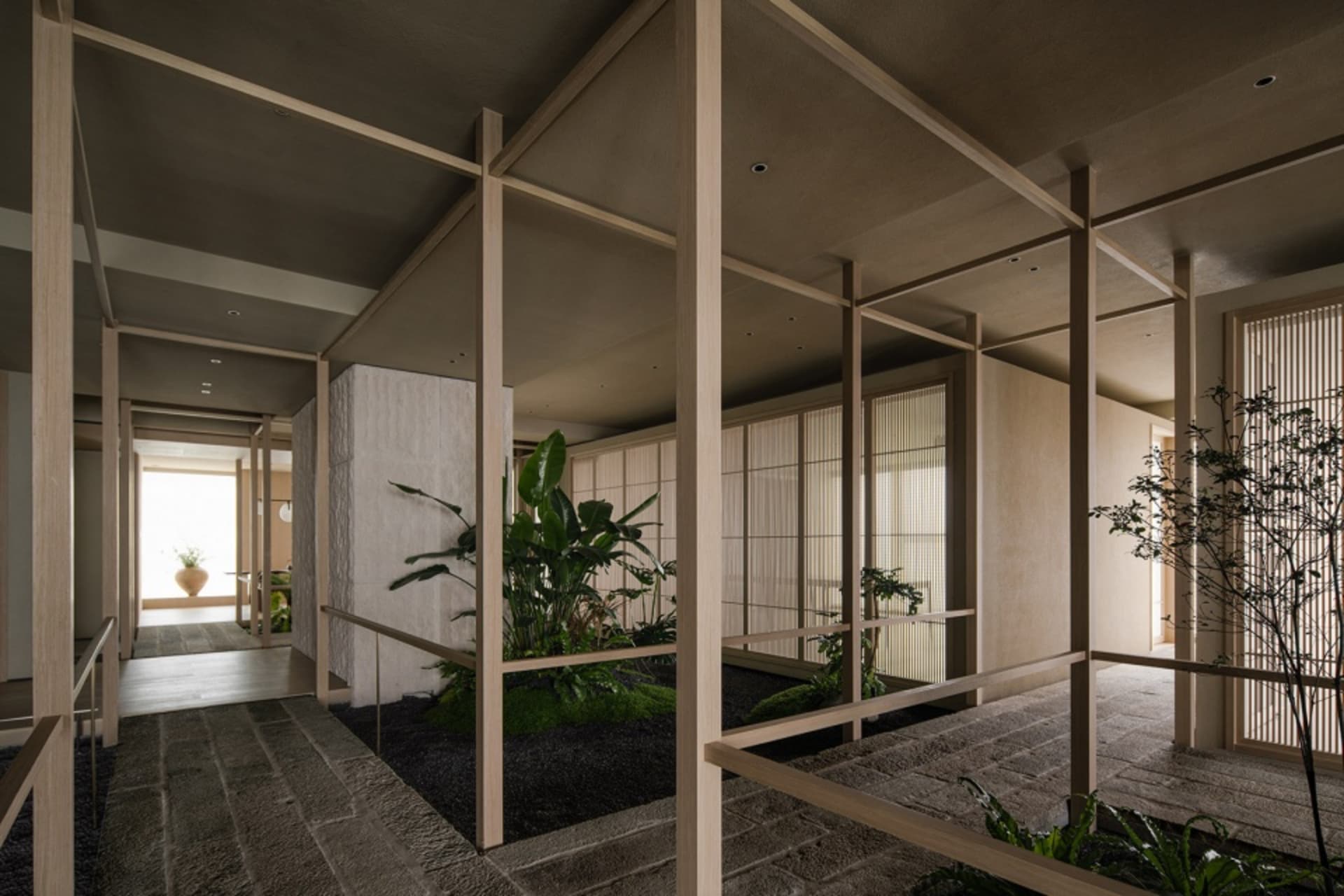 Bright and inviting modern space with white walls, wooden accents, and natural light from windows, featuring potted plants and wooden beams