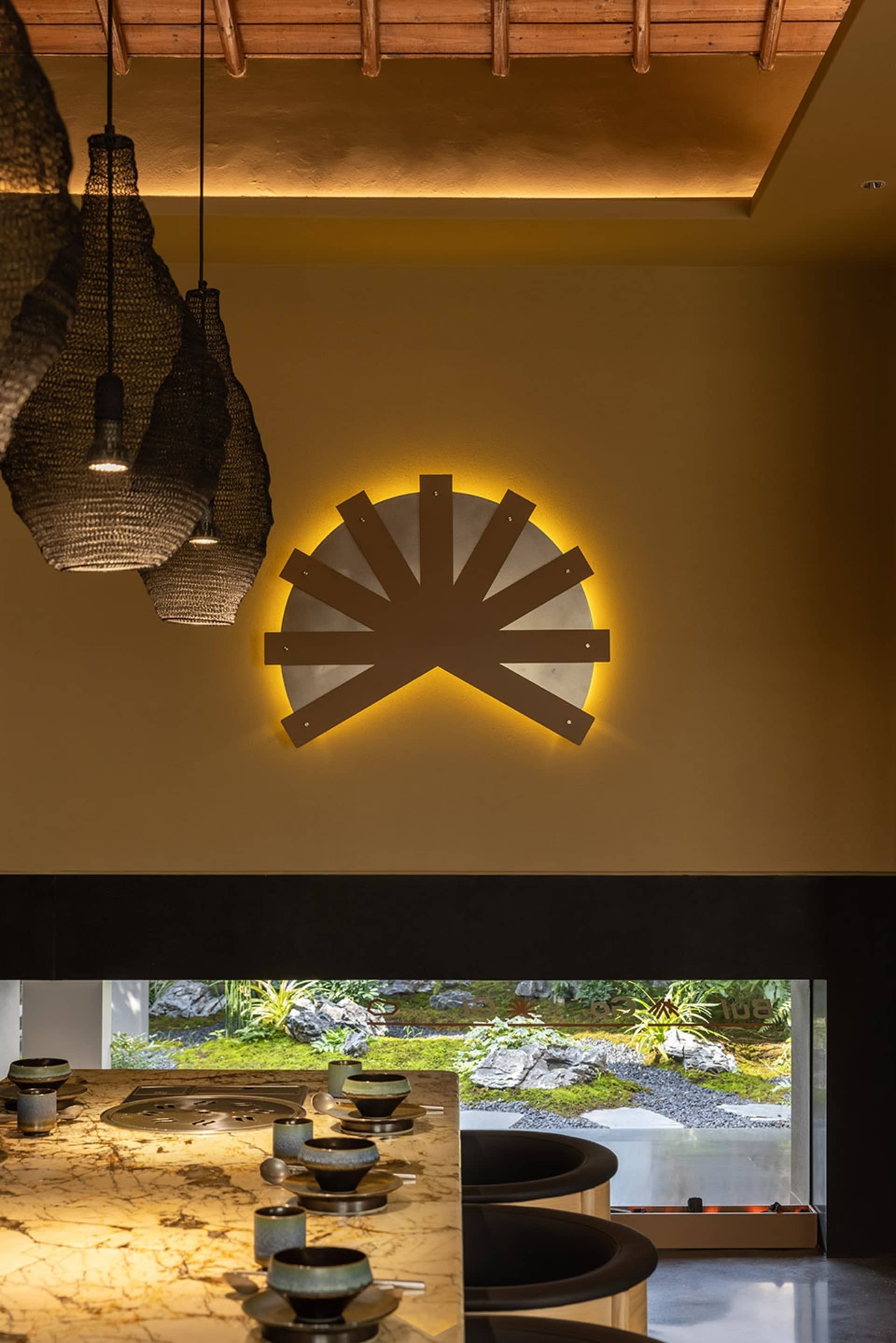 Inviting dining area with a yellow wall, a table, chairs, and decorative vases