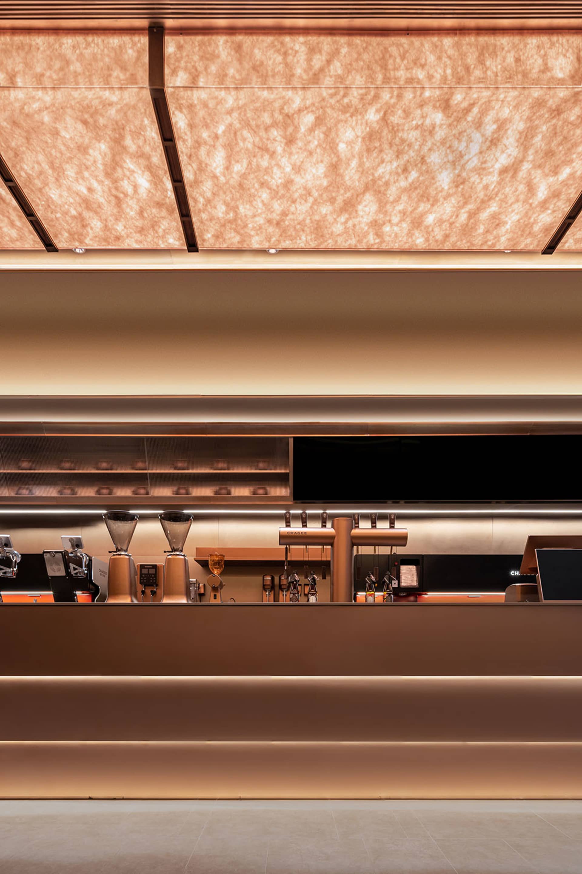 A cozy bar area with a counter featuring various items, TVs mounted on the wall, and a welcoming atmosphere