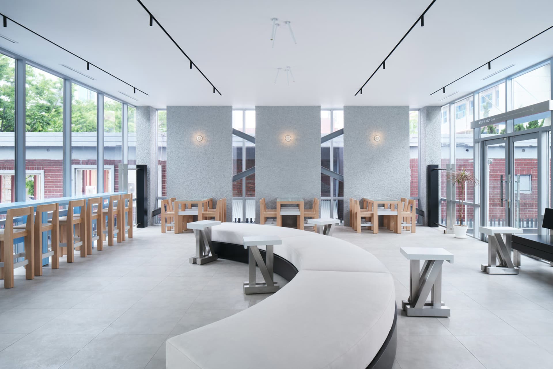 Open restaurant interior with modern design, multiple tables, benches, and warm ambient lighting