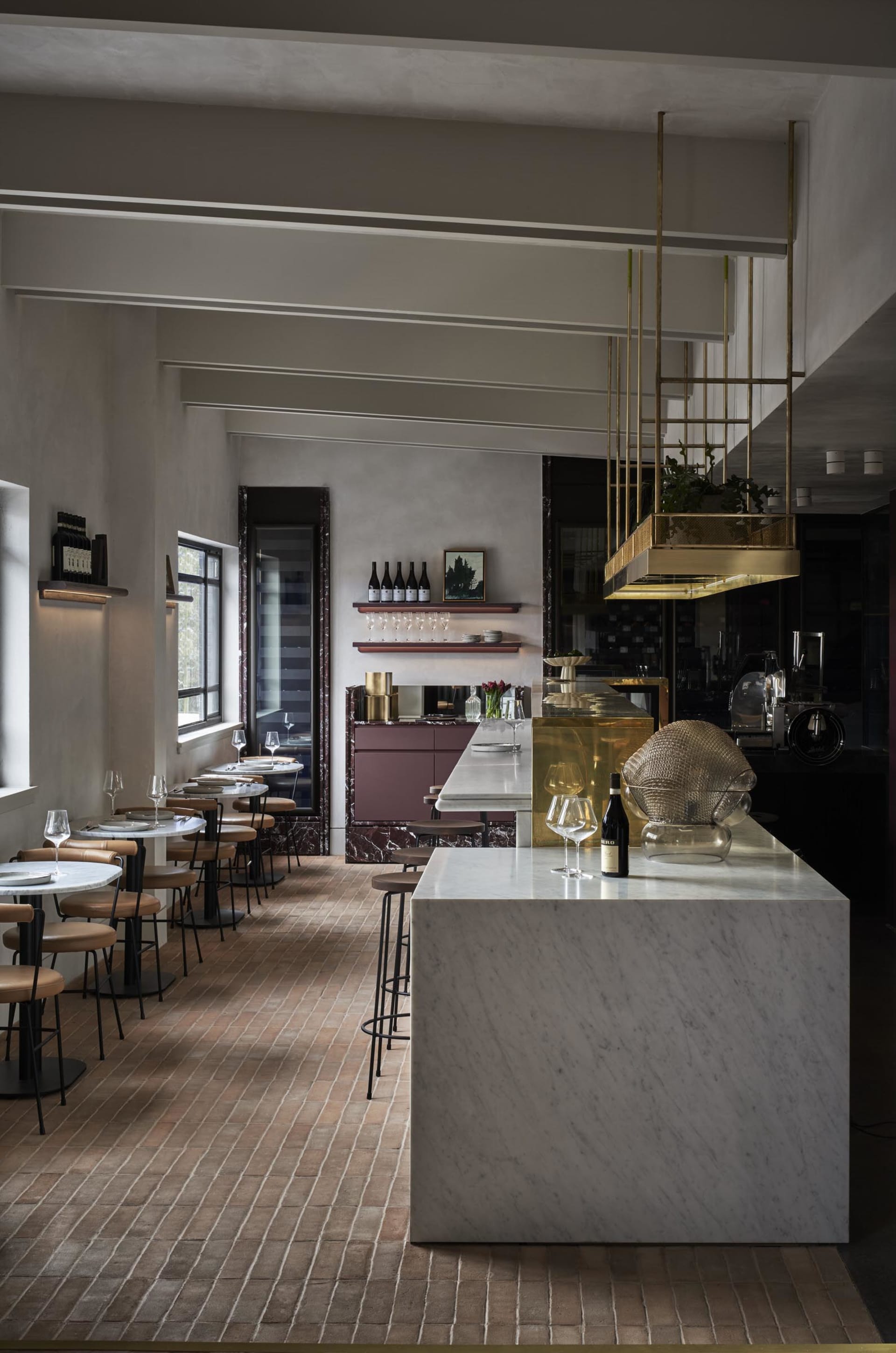 elegant restaurant interior with a marble bar, wine glasses, and wine bottles displayed in a modern and stylish environment