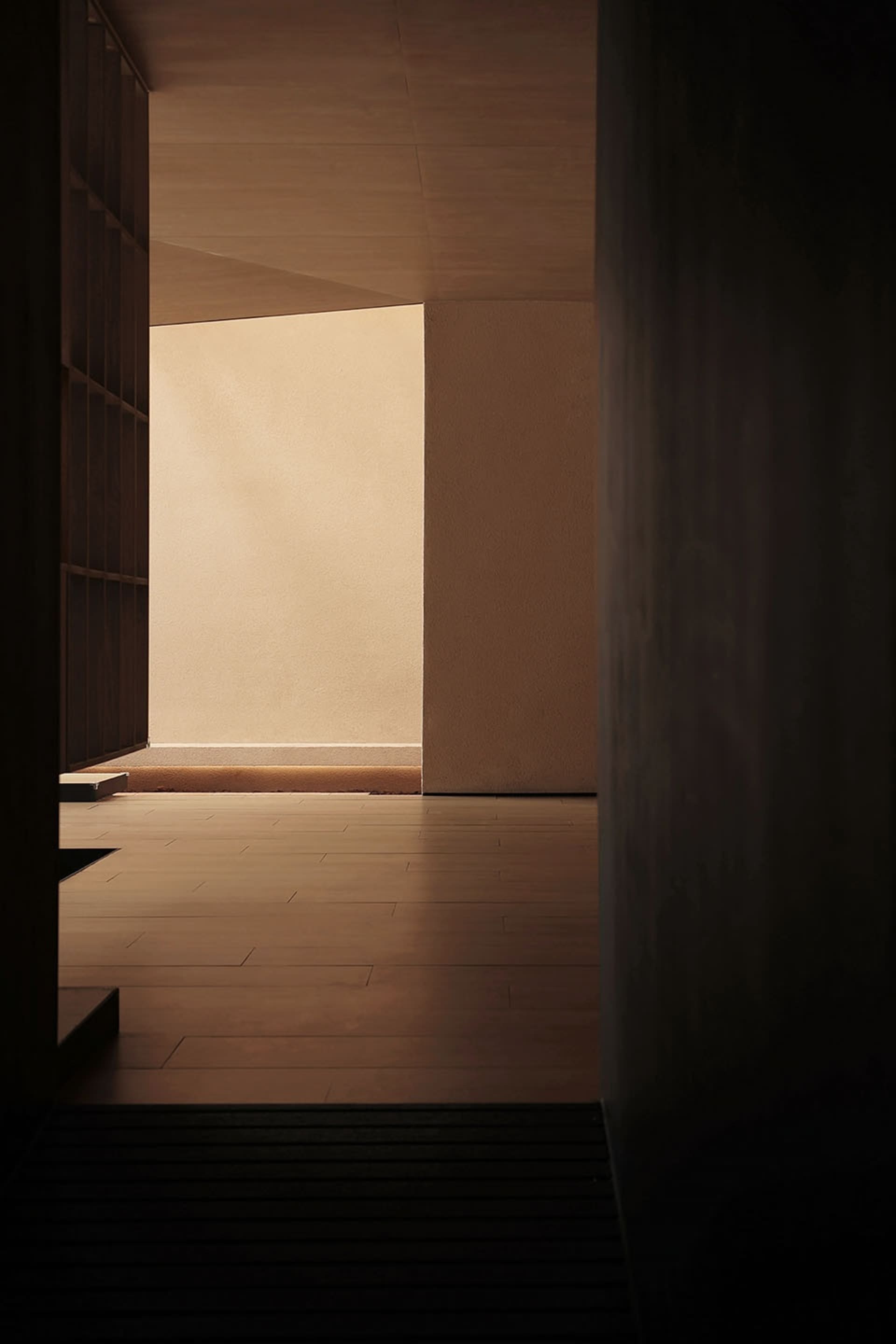 Empty room with wooden floor and white walls, providing a clean and minimalist space