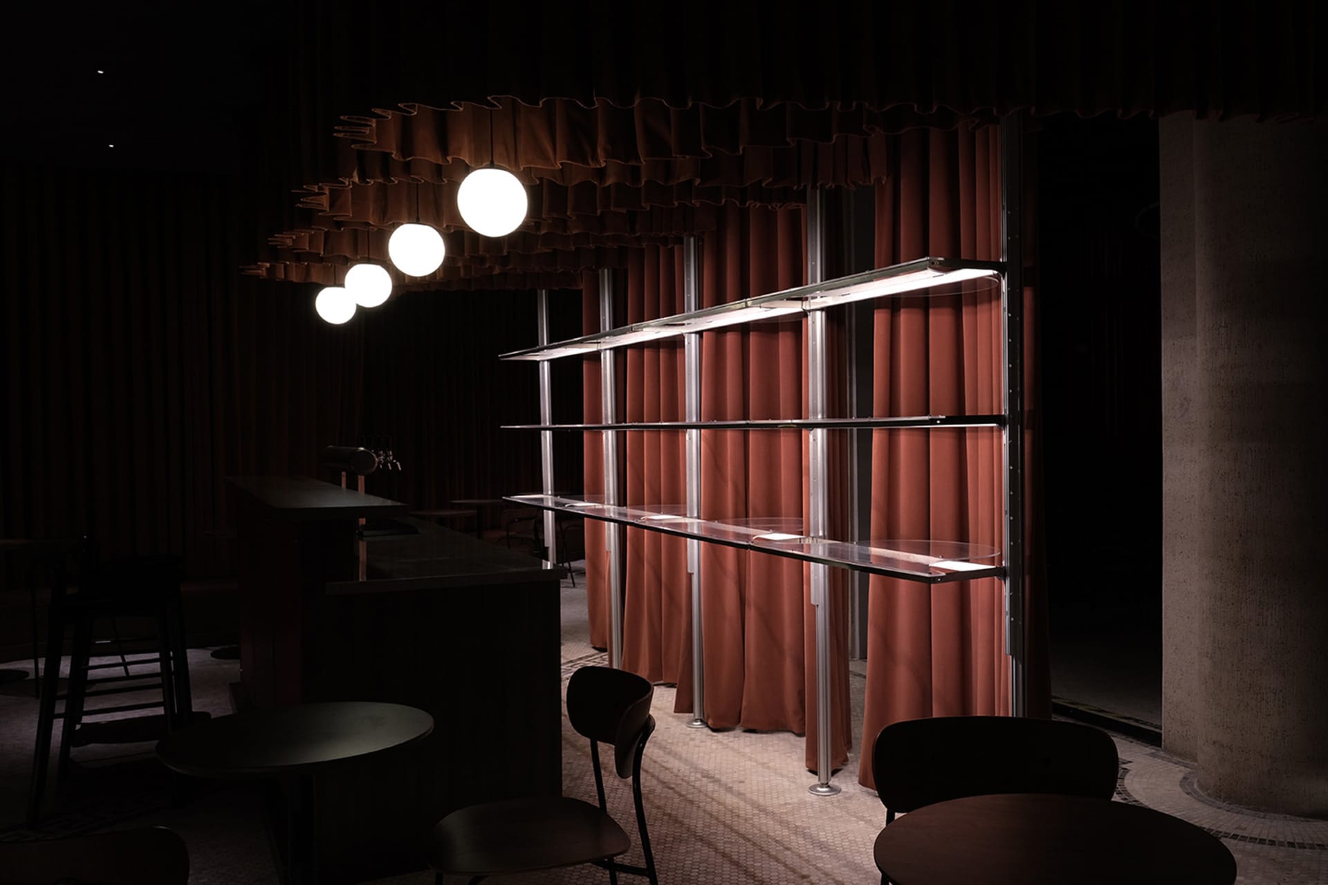 A modern restaurant interior with a counter and three chairs, a cozy atmosphere, and a curtain covering part of the window