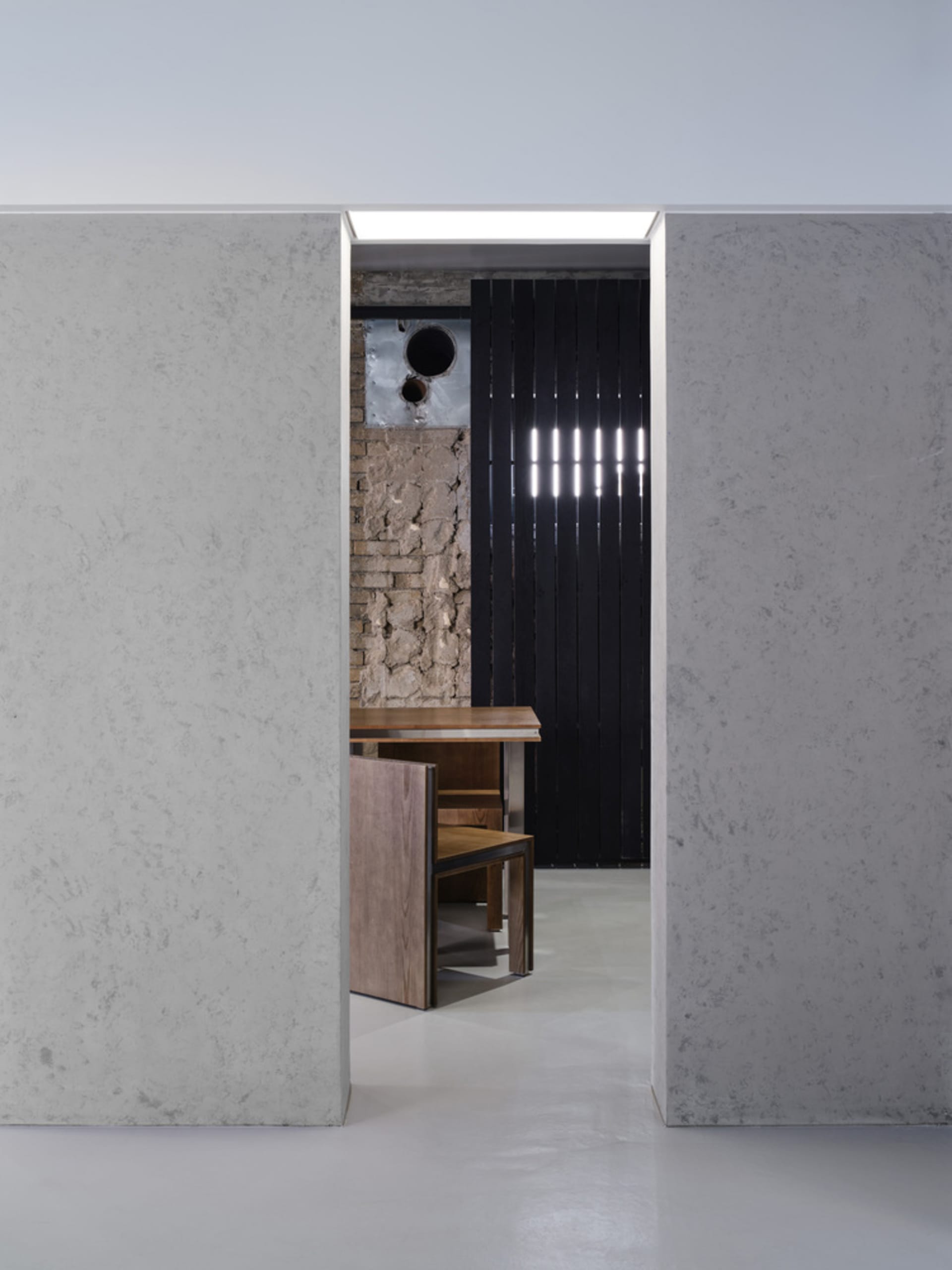 Cozy kitchen dining space with a brick design, a dining table, chairs, and a sink, perfect for gatherings and meals