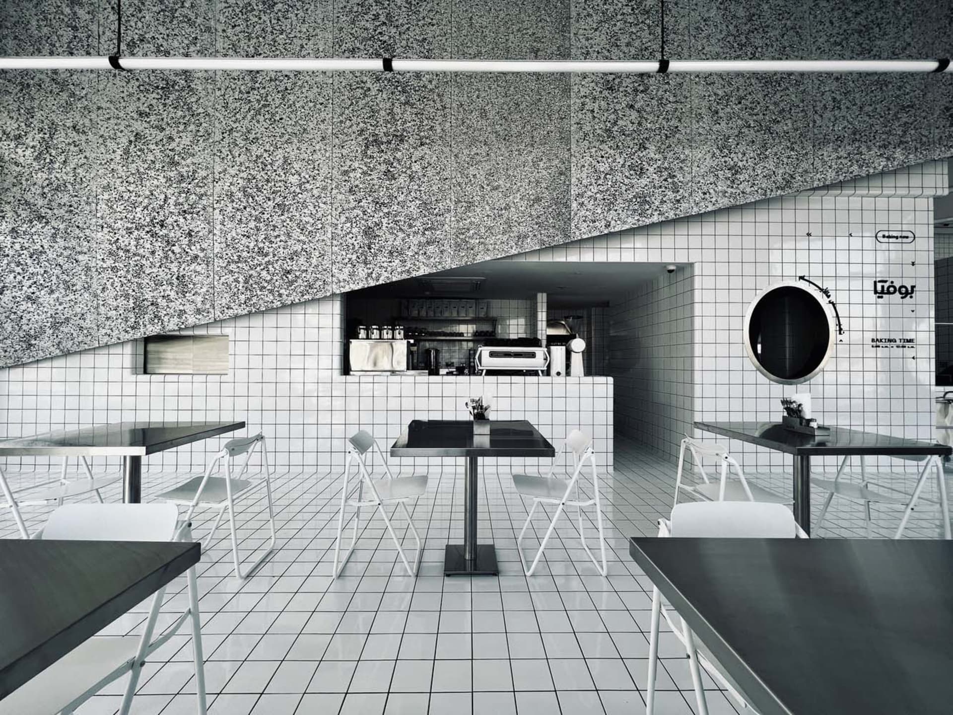 Empty restaurant interior with white tables and chairs, clean and well-organized, ready for customers