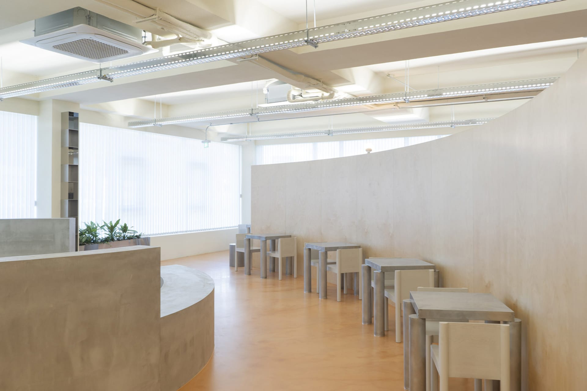A bright and inviting space with multiple wooden tables and metal chairs, ideal for social gatherings or events