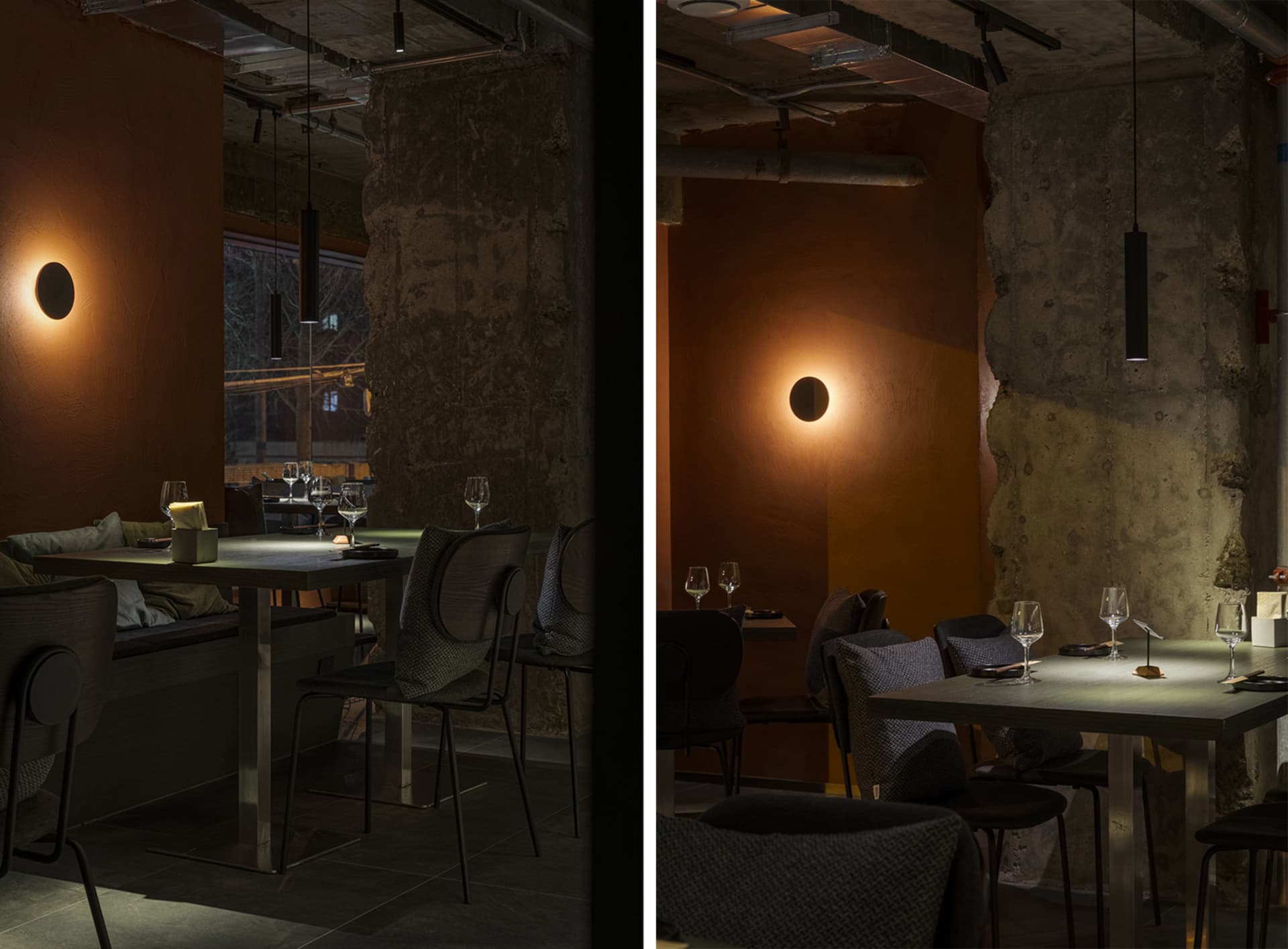 Dimly lit restaurant interior with modern furniture, clean lines, and minimalistic design elements, featuring wine glasses and tables