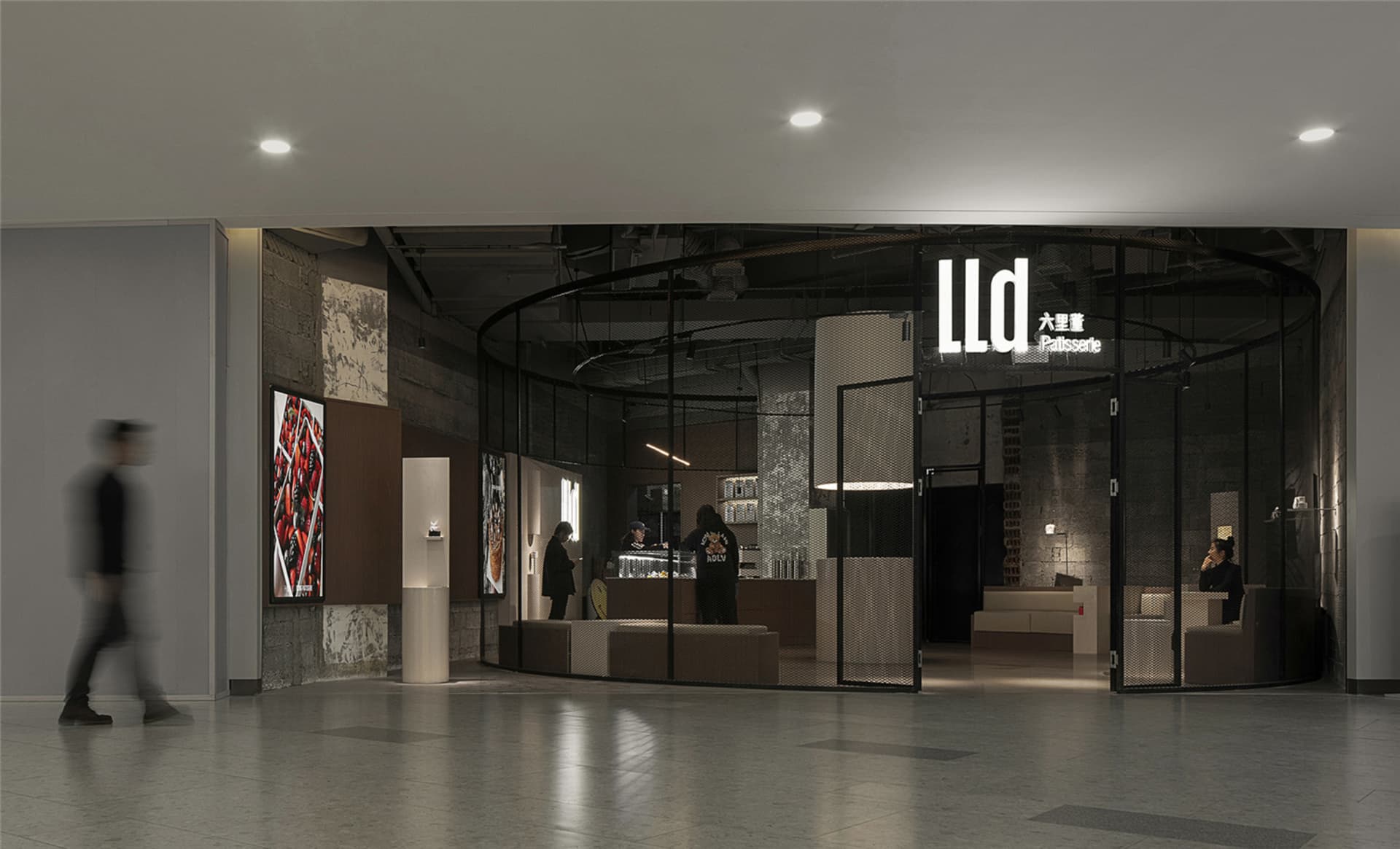 Bright and welcoming retail space with modern design, glass partitions, and TV screens on the walls