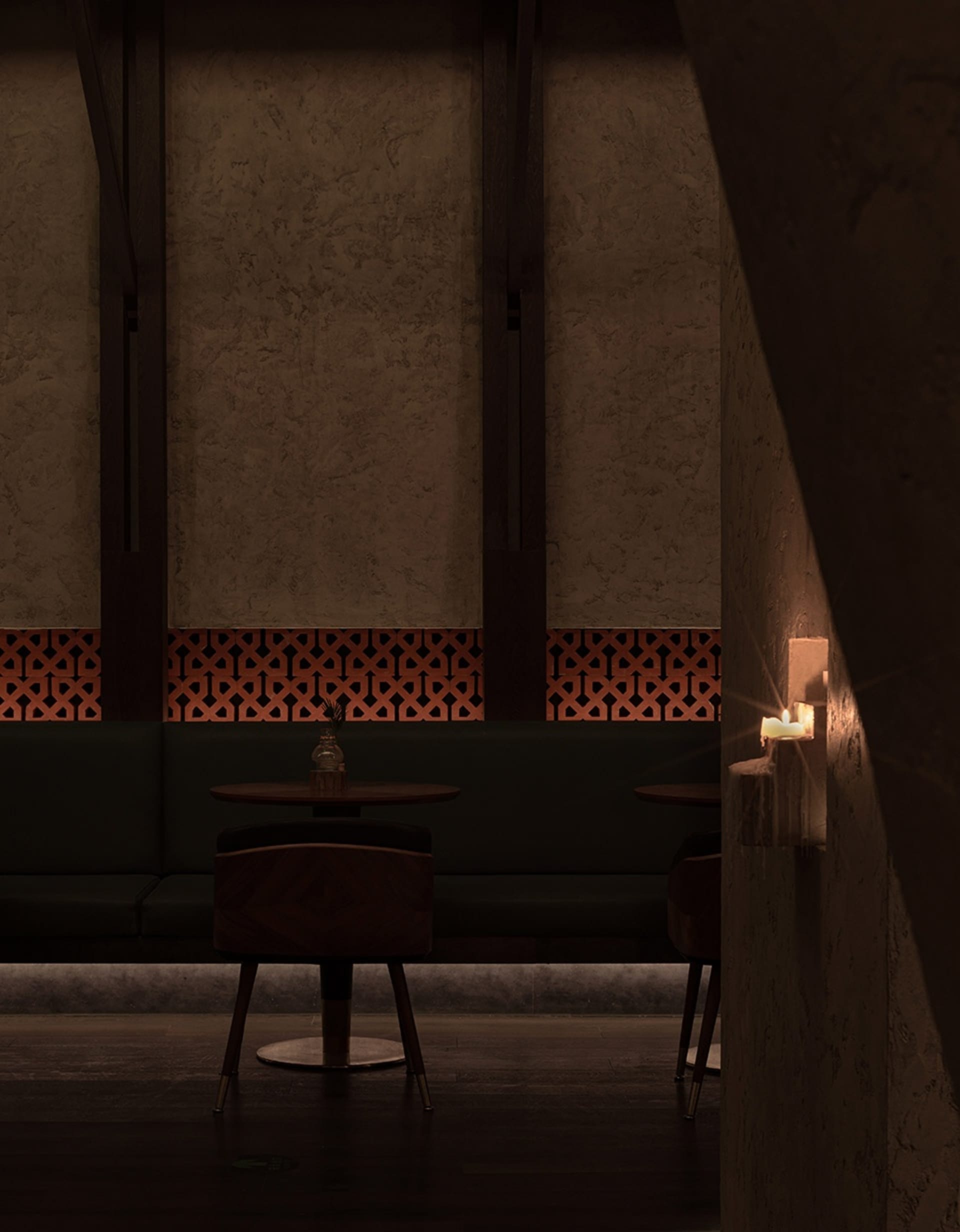 An inviting restaurant interior with a dining table, patterned walls, and a vase on the table