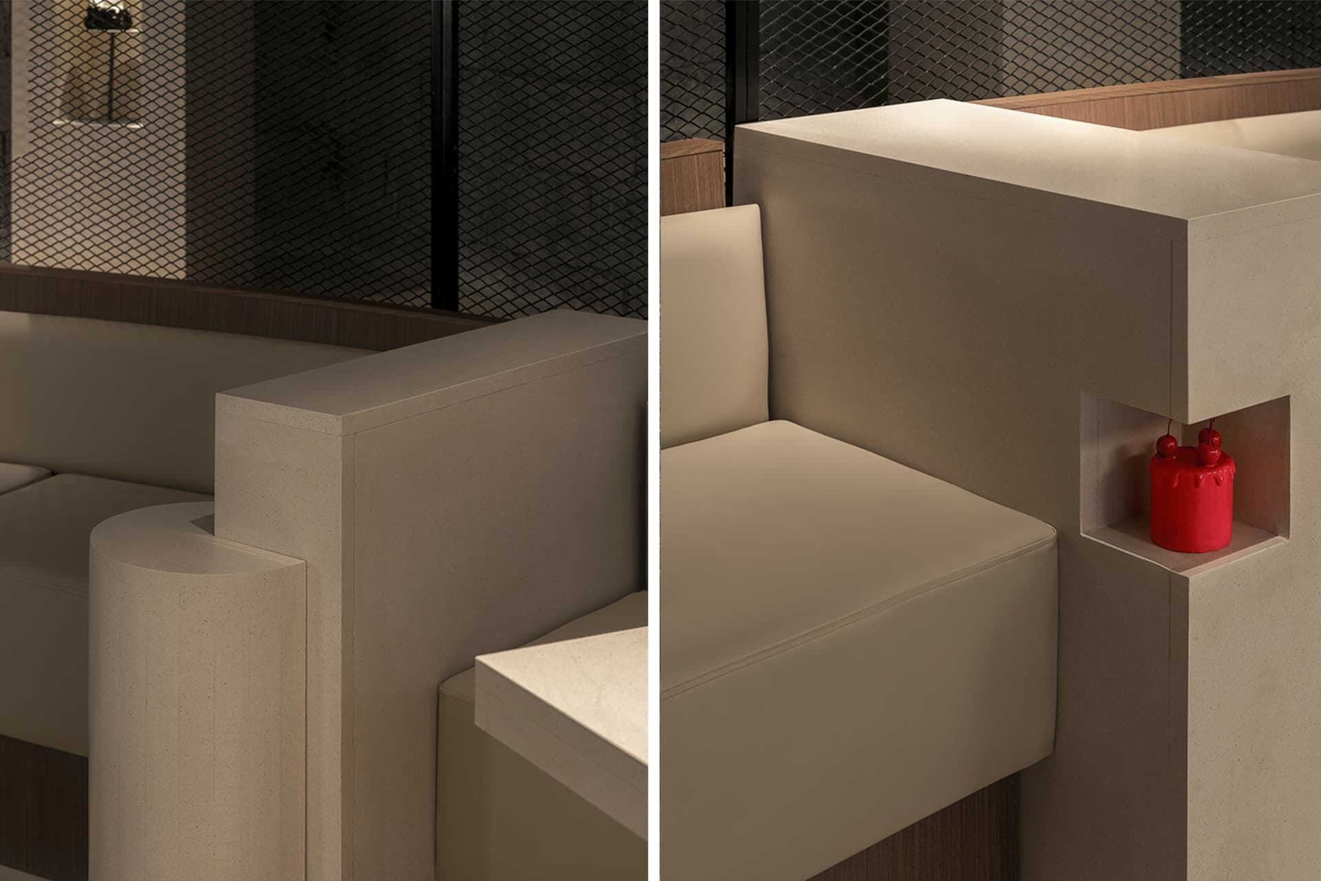A living area with a leather couch and a fabric couch, both against a stone wall, with chairs and a cozy atmosphere