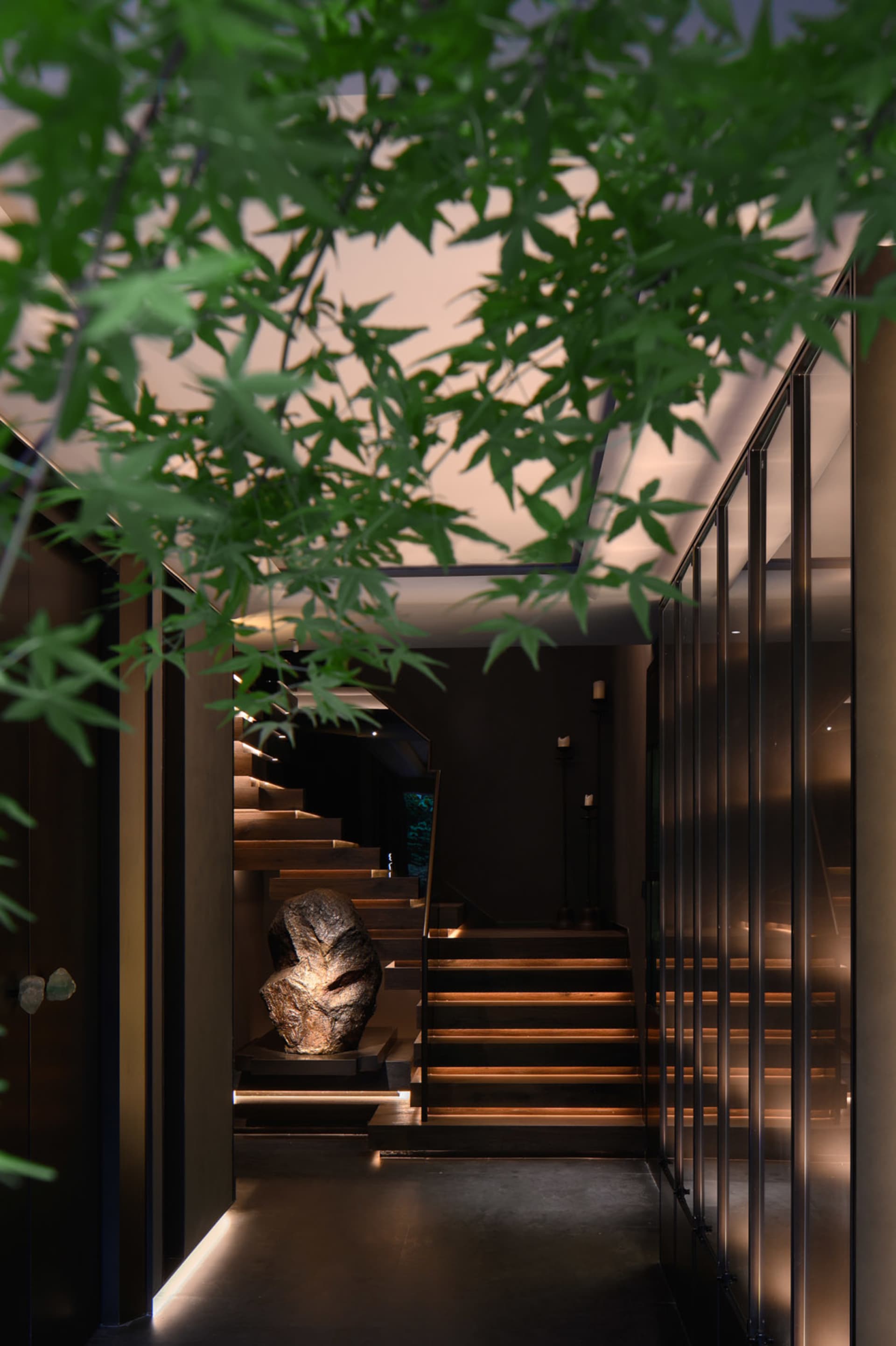 A dark and moody image of a building with two sets of wooden staircases and black metal railings