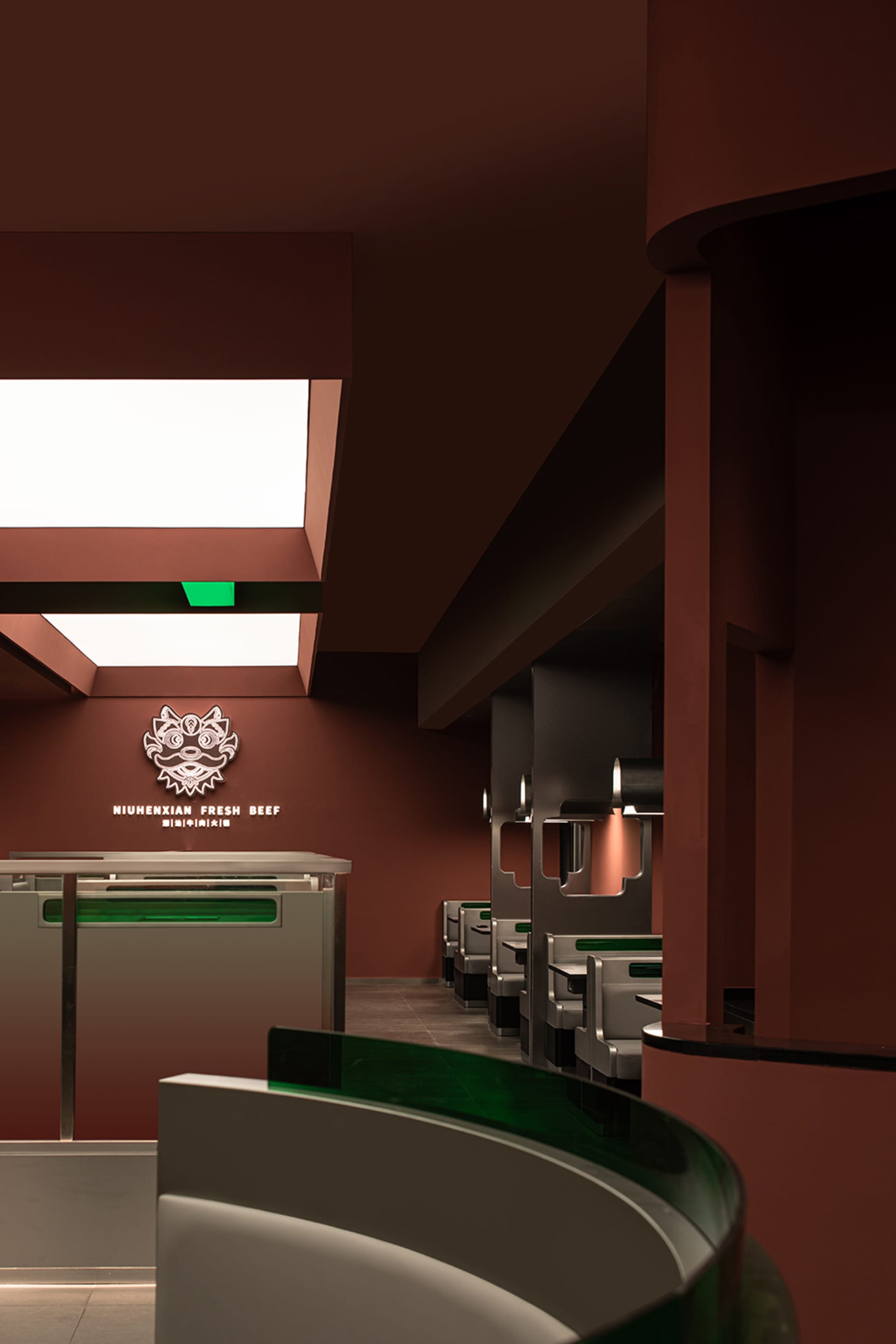 Modern restaurant interior with tables, chairs, couches, artwork, and a modern design