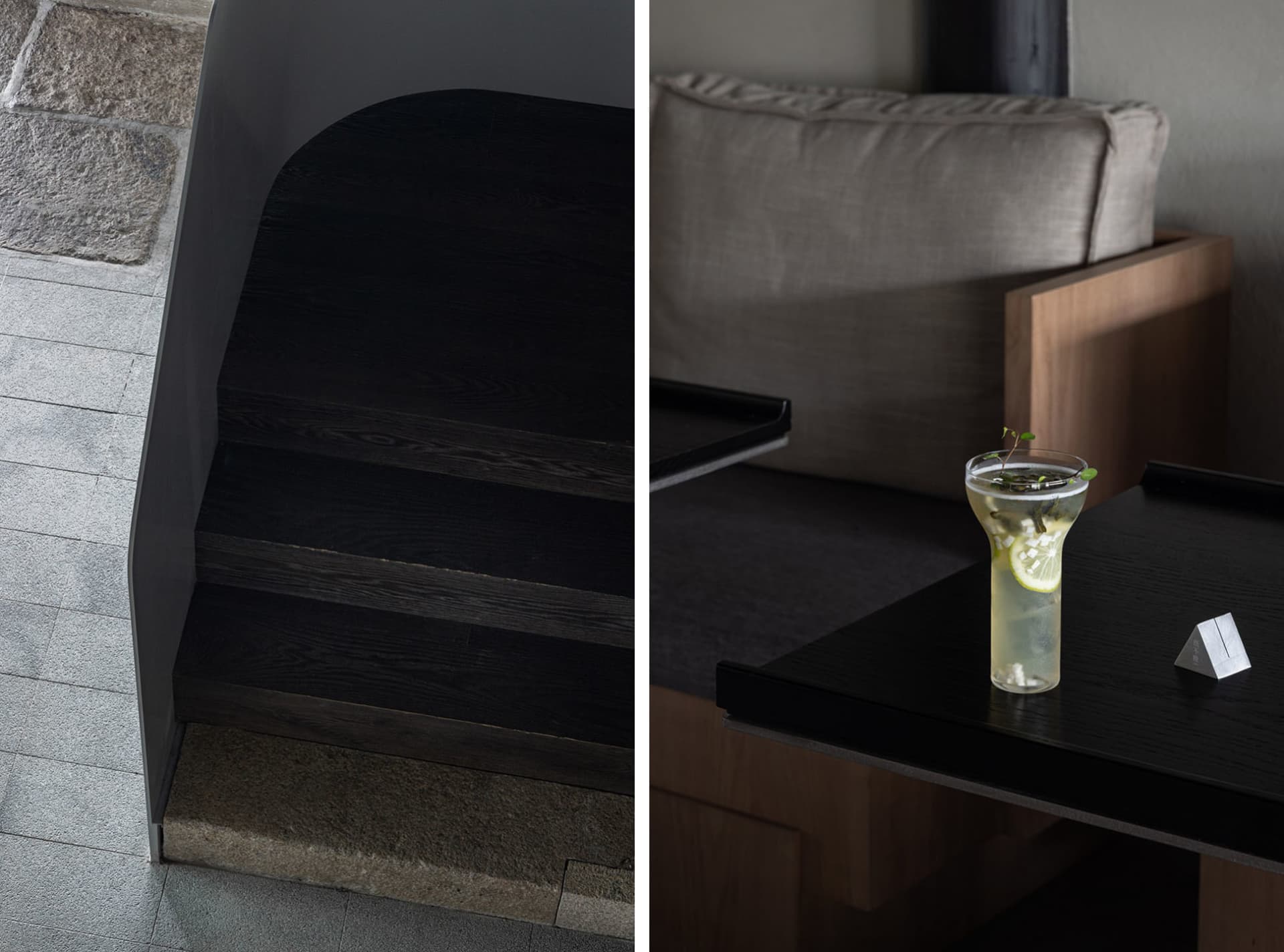 Modern living space with a staircase, a couch, a dining table, and bottles on surfaces