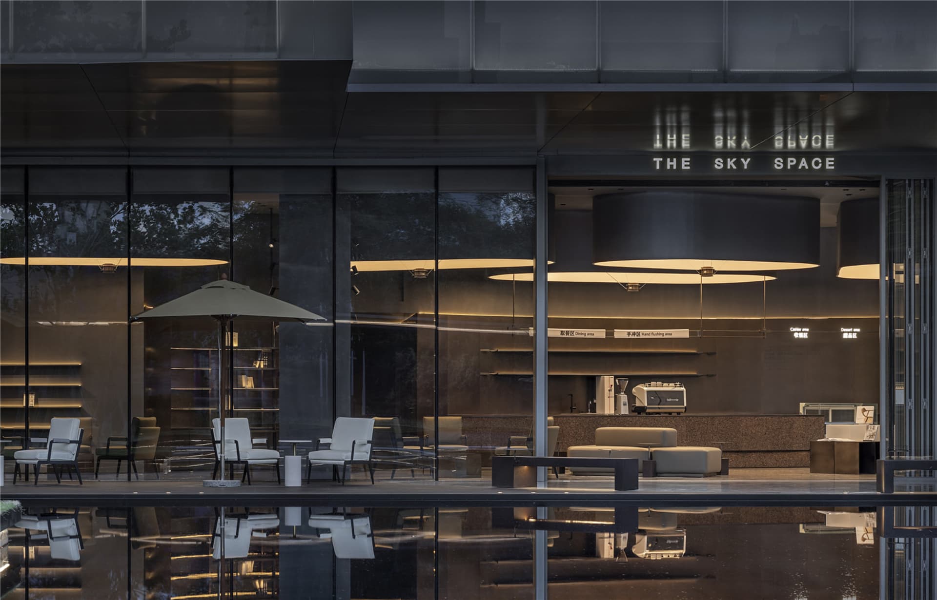 A restaurant with comfortable seating areas, umbrellas, and a relaxed atmosphere