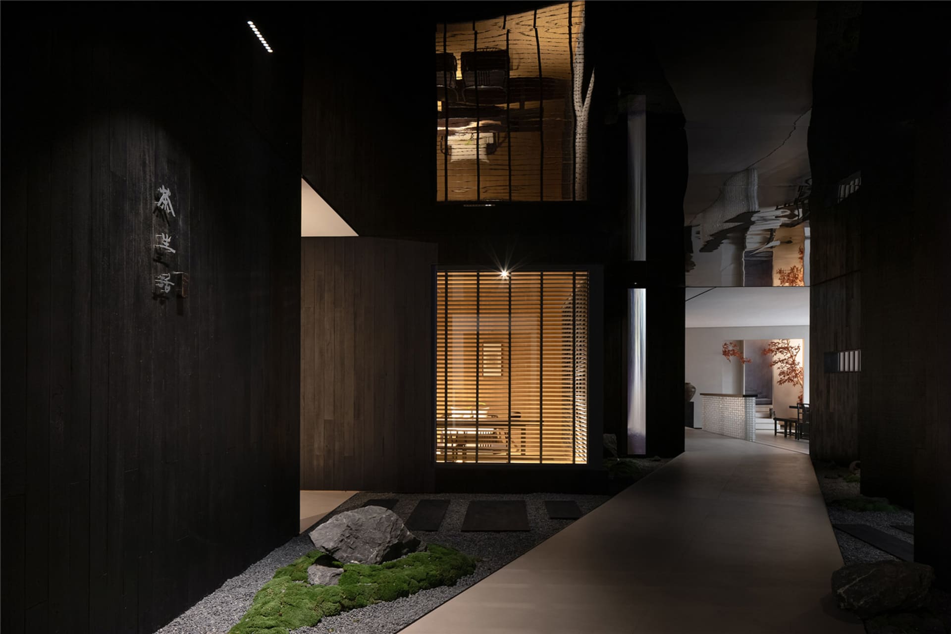 Asian-style house with a black exterior, featuring a large window, two chairs, and a dining table in a cozy and inviting living area