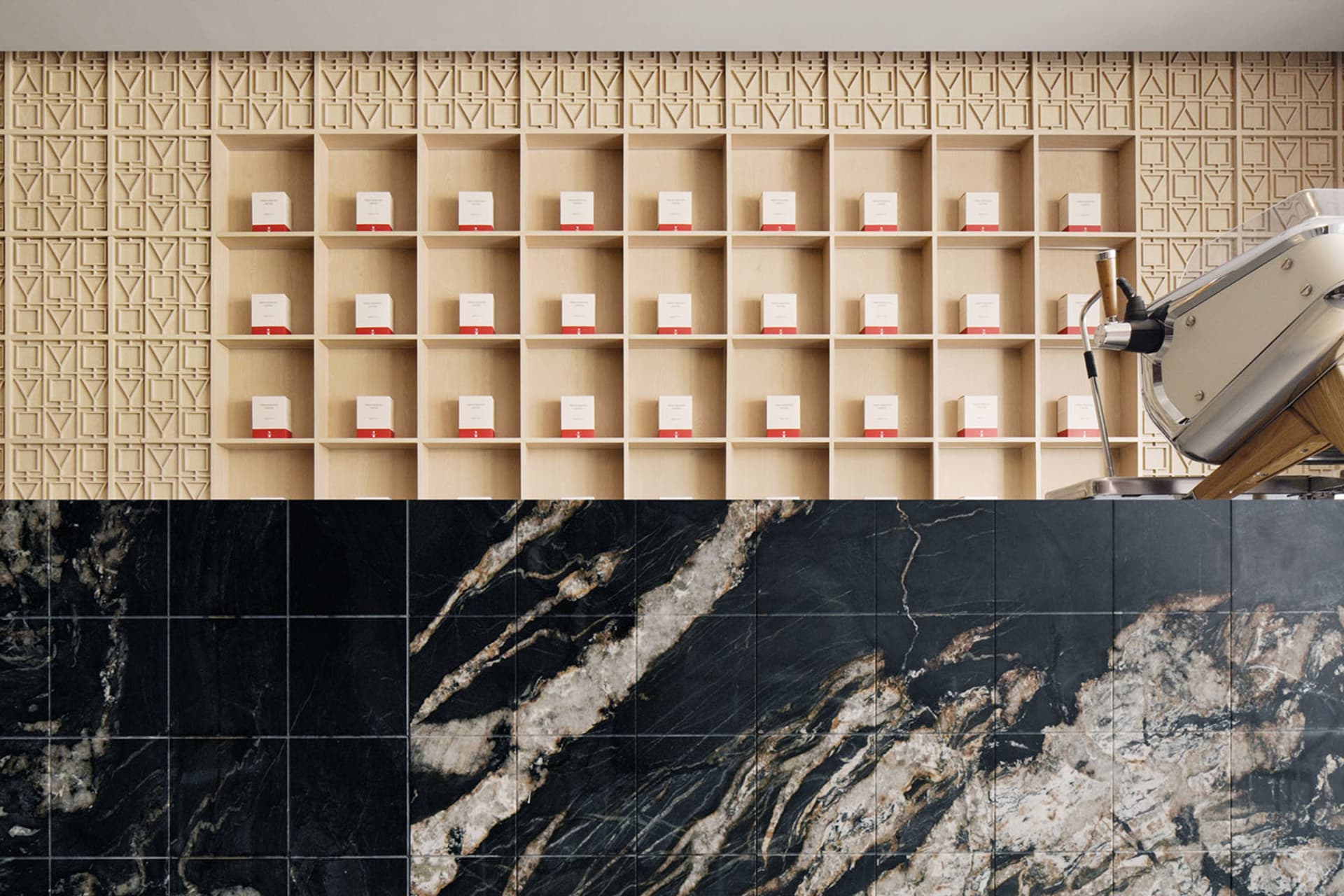 Marble countertop display with bottles and cups in a well-organized retail environment