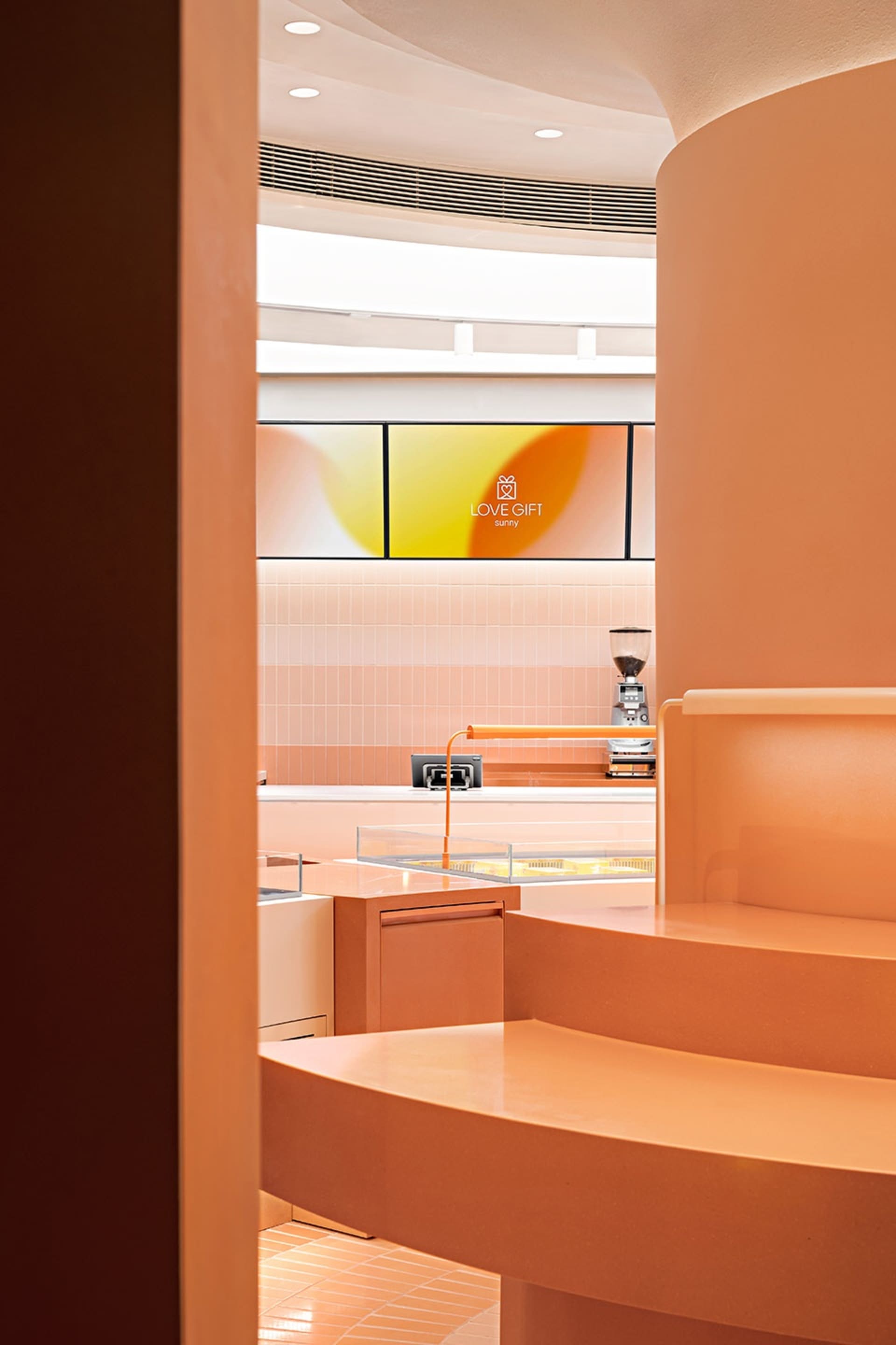Warm and inviting kitchen with orange accents, a countertop, sink, and appliances