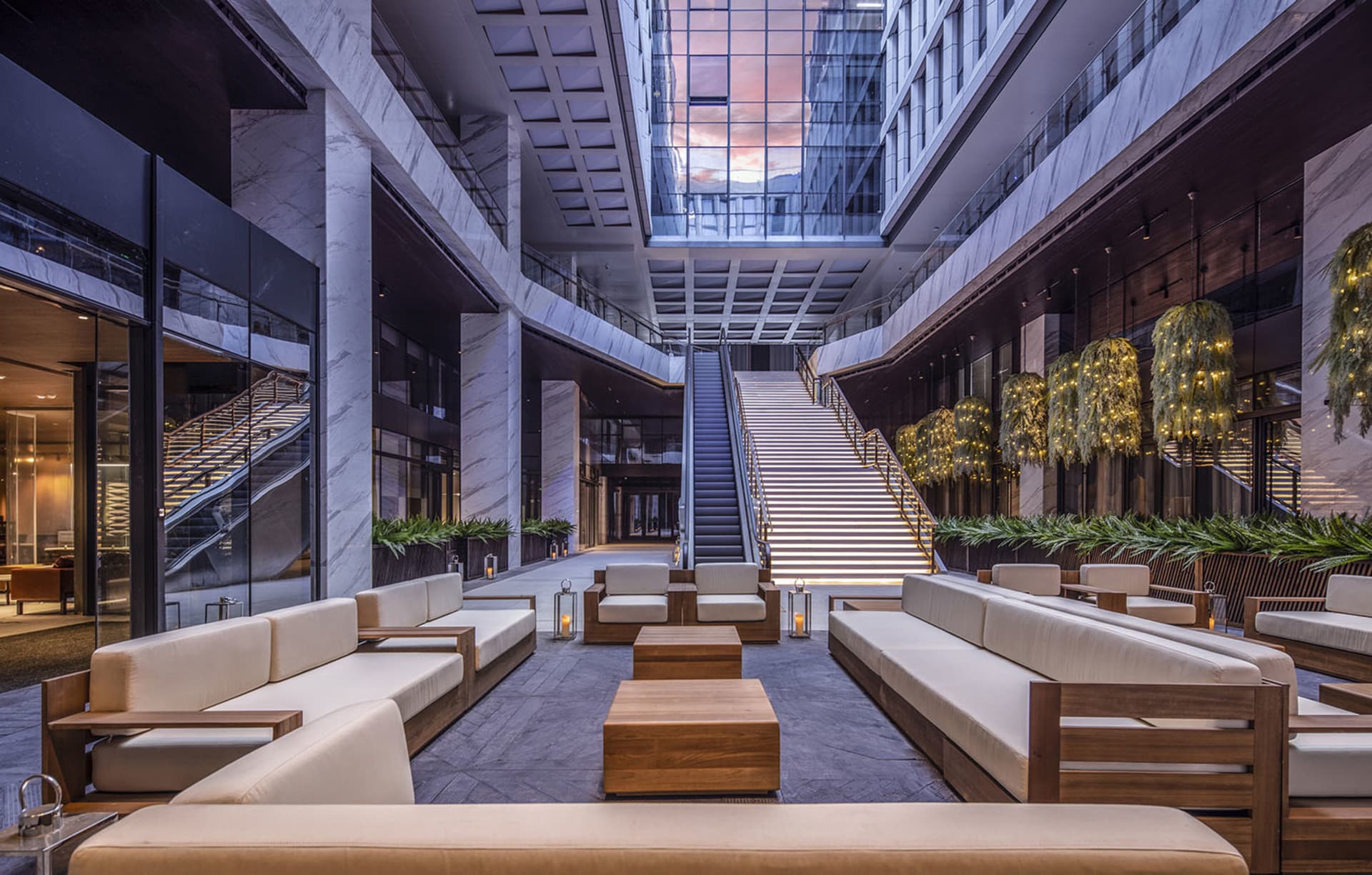Comfortable lobby with couches, chairs, and potted plants, creating a welcoming atmosphere