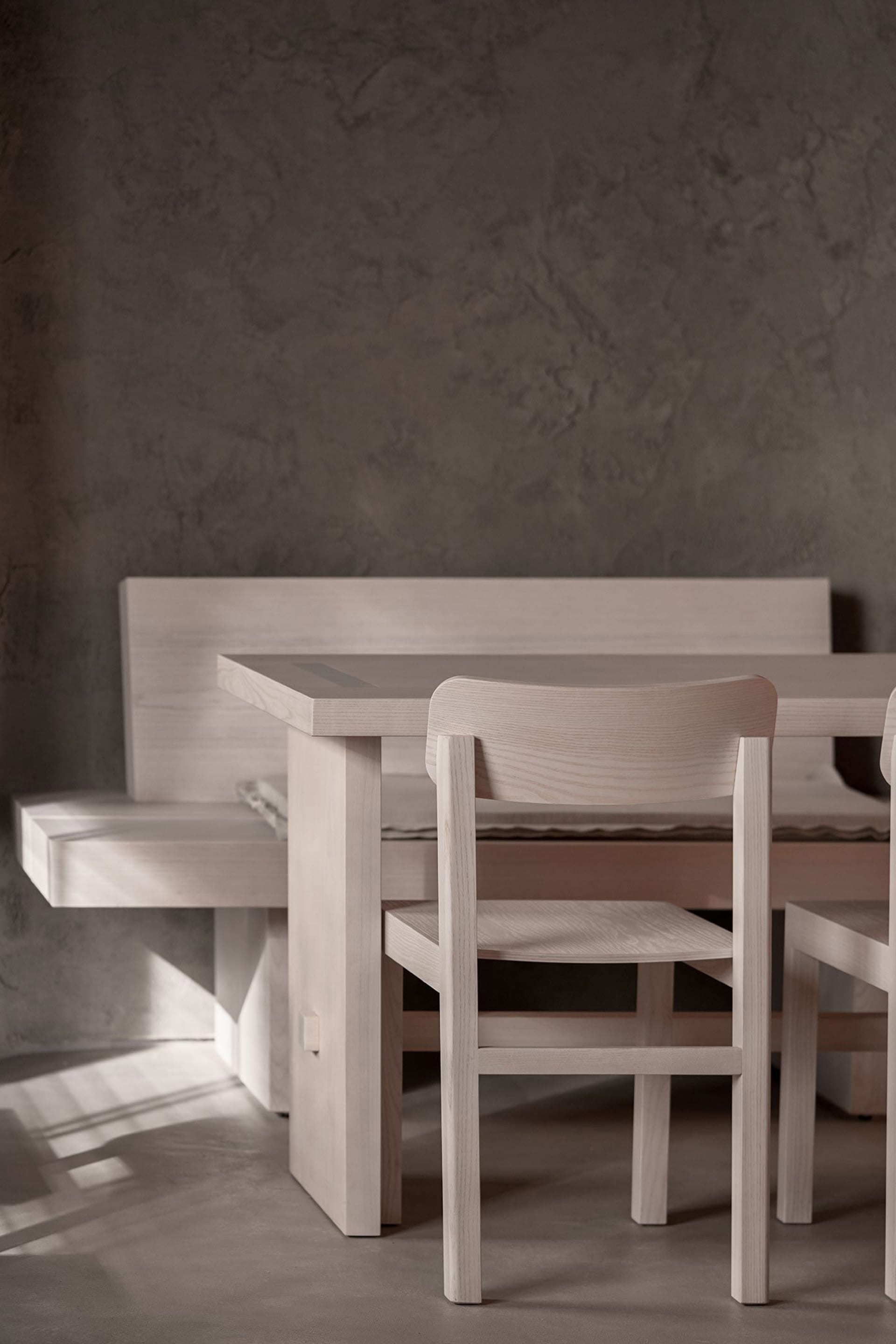 Empty dining area with wooden tables and chairs, creating a calm and inviting atmosphere