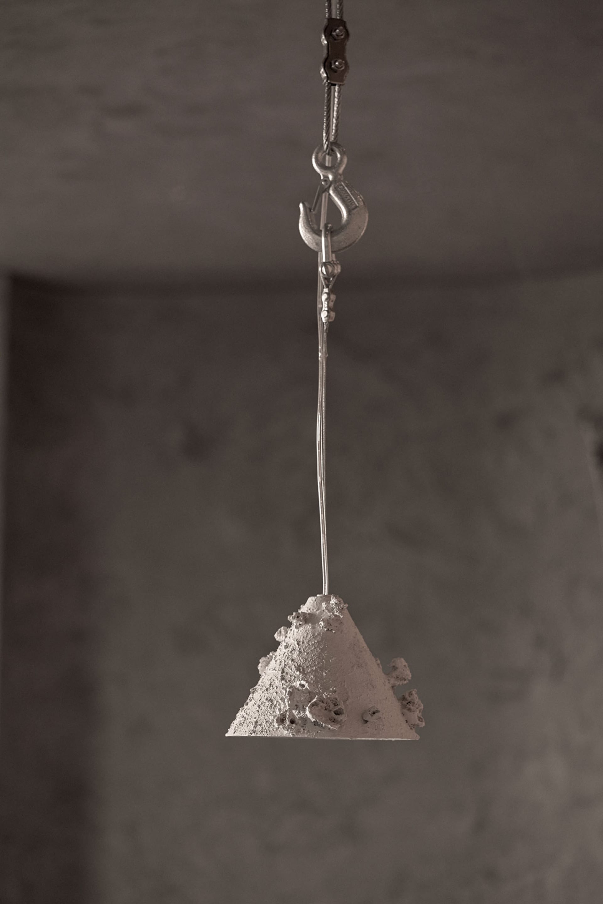 A restaurant interior with a sand sculpture hanging from the ceiling, showcasing intricate design elements and architectural details