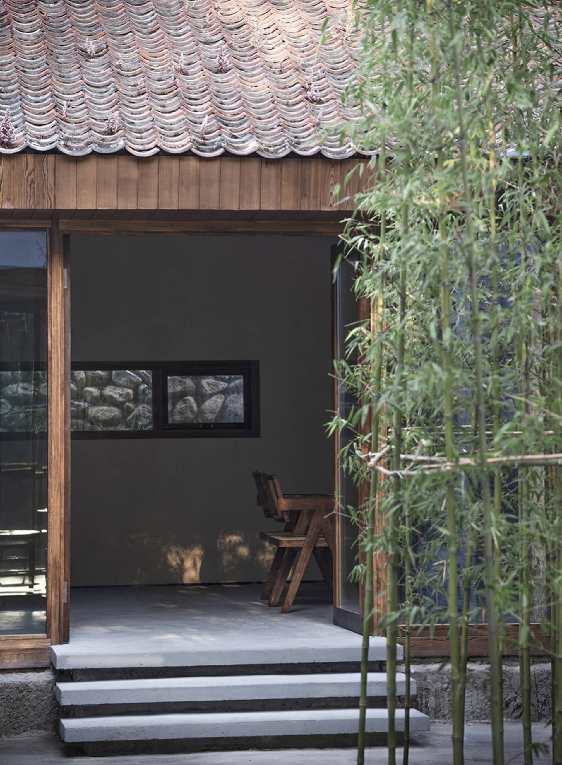 A small room with a wooden floor and a chair, creating a calm and inviting atmosphere