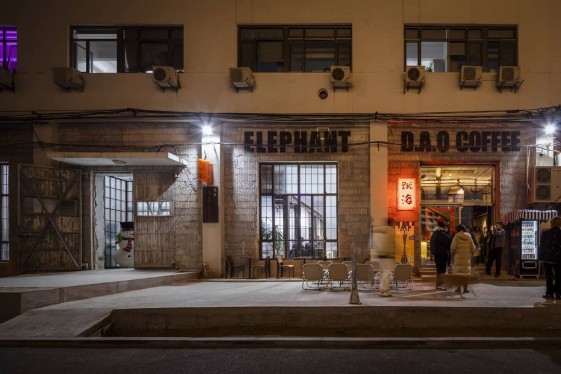 A well-lit Asian restaurant at night with a prominent sign reading Elephant and outdoor seating for customers