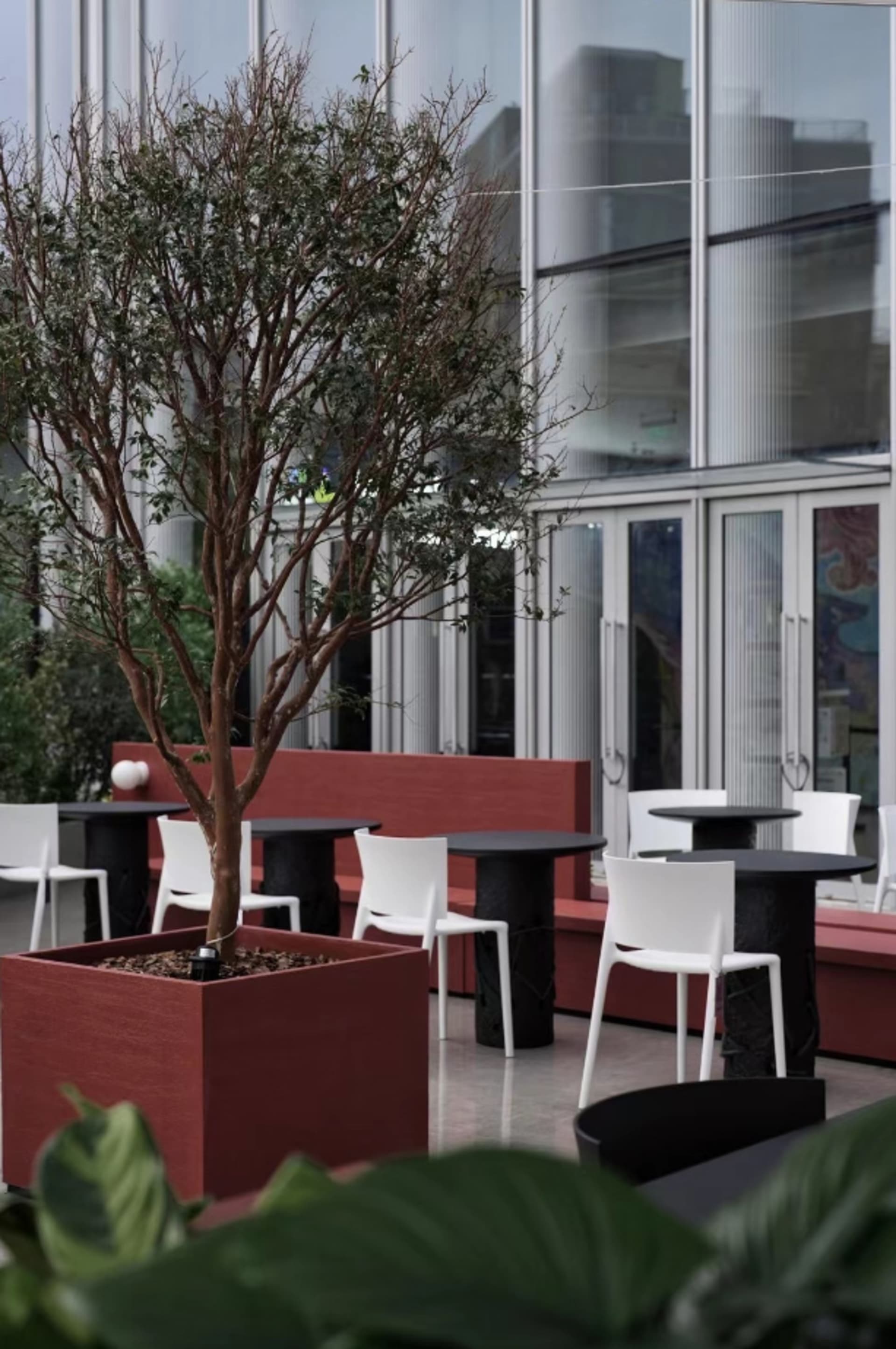 A dining area with multiple tables and chairs, benches, and an inviting atmosphere for socializing and meals