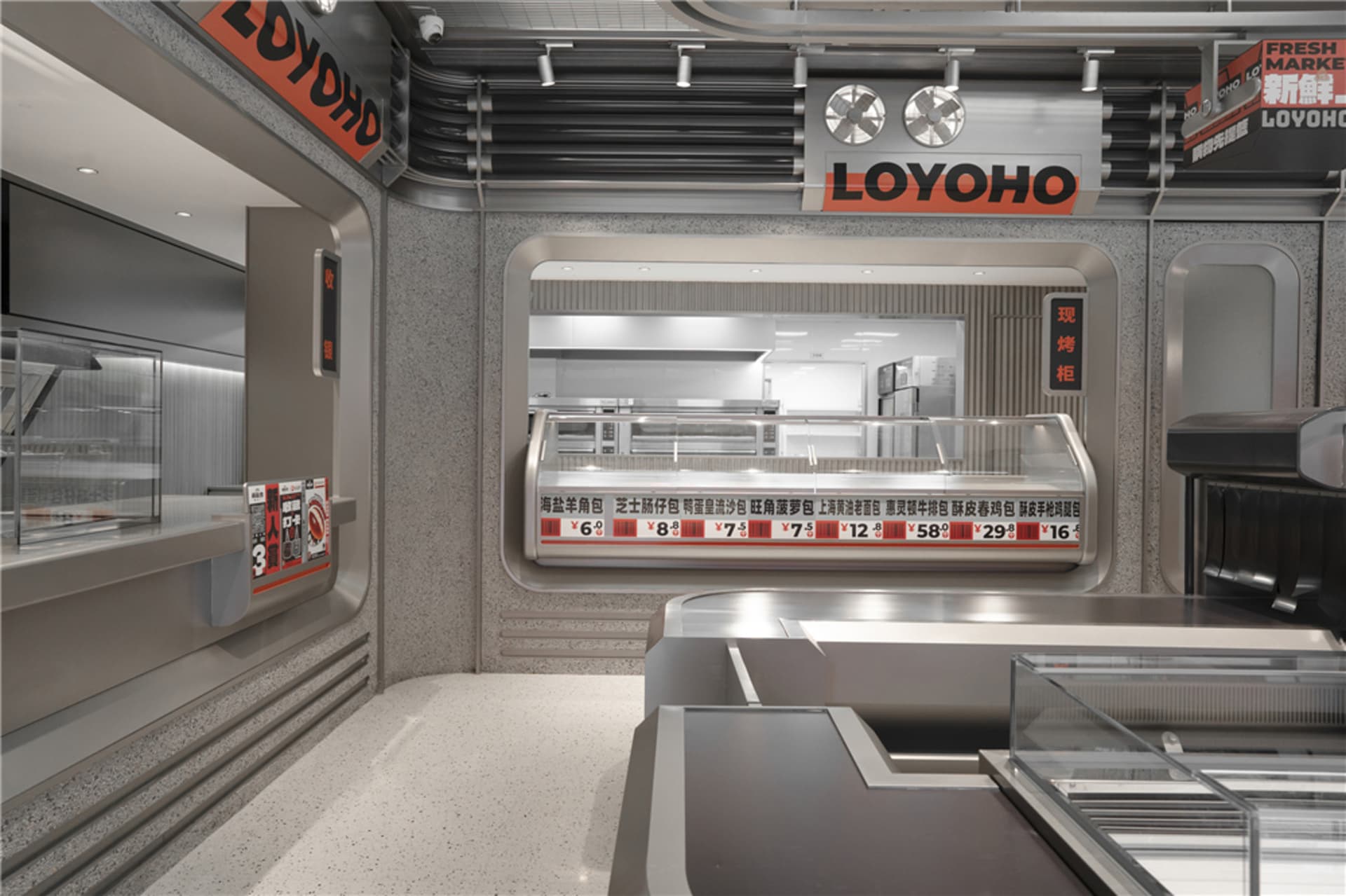 A modern restaurant interior with a metal counter, staircase, and seating area, creating a clean and formal dining atmosphere