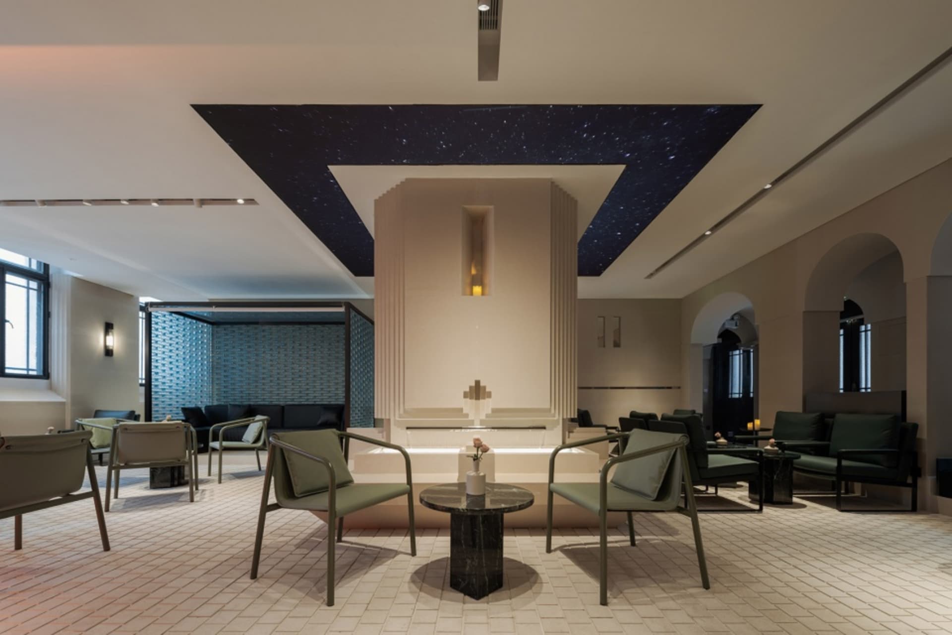 A cozy cafe with star pattern walls, comfortable seating, and dining tables