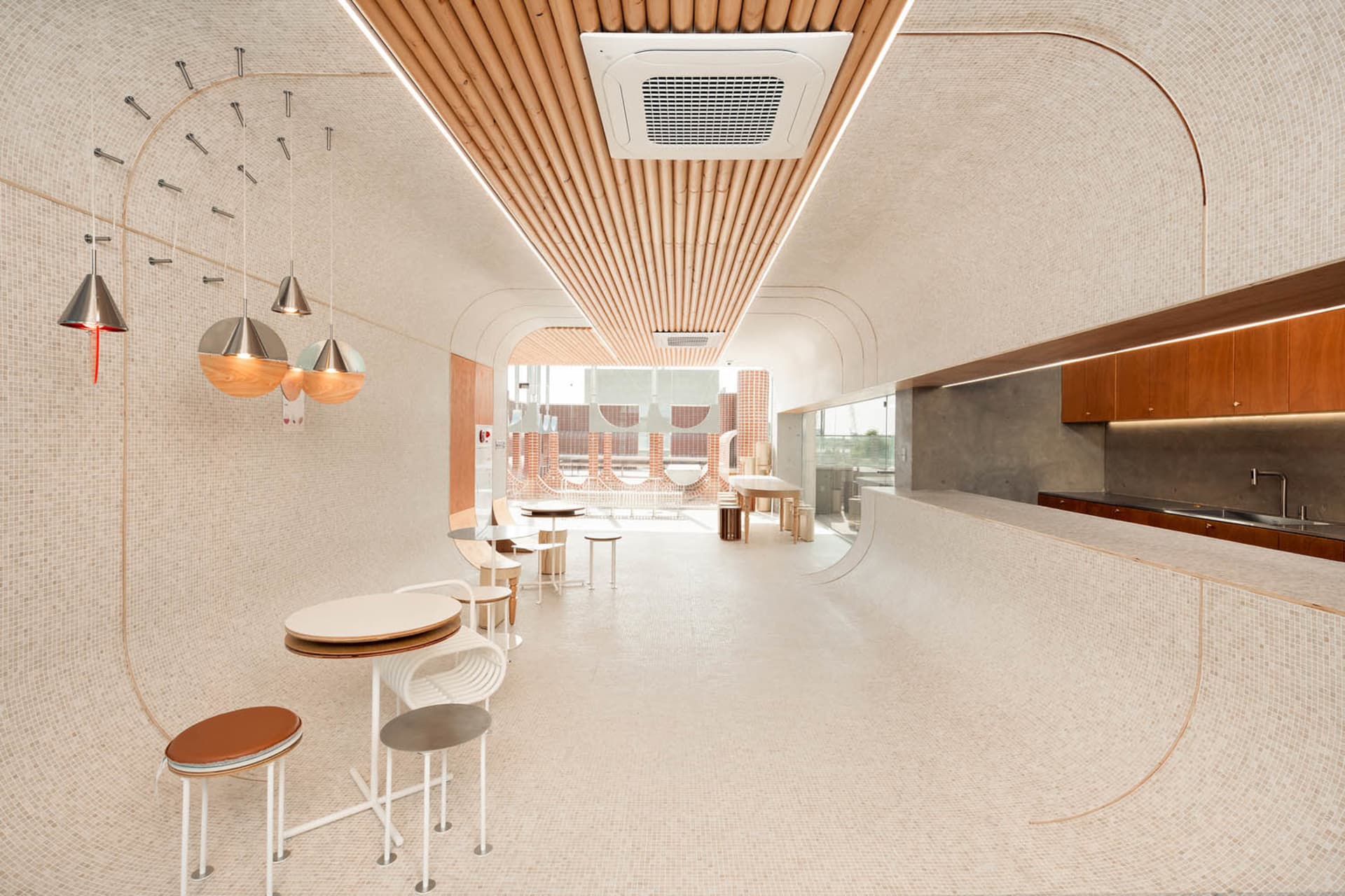 Modern restaurant interior with multiple dining tables, chairs, and tiled flooring