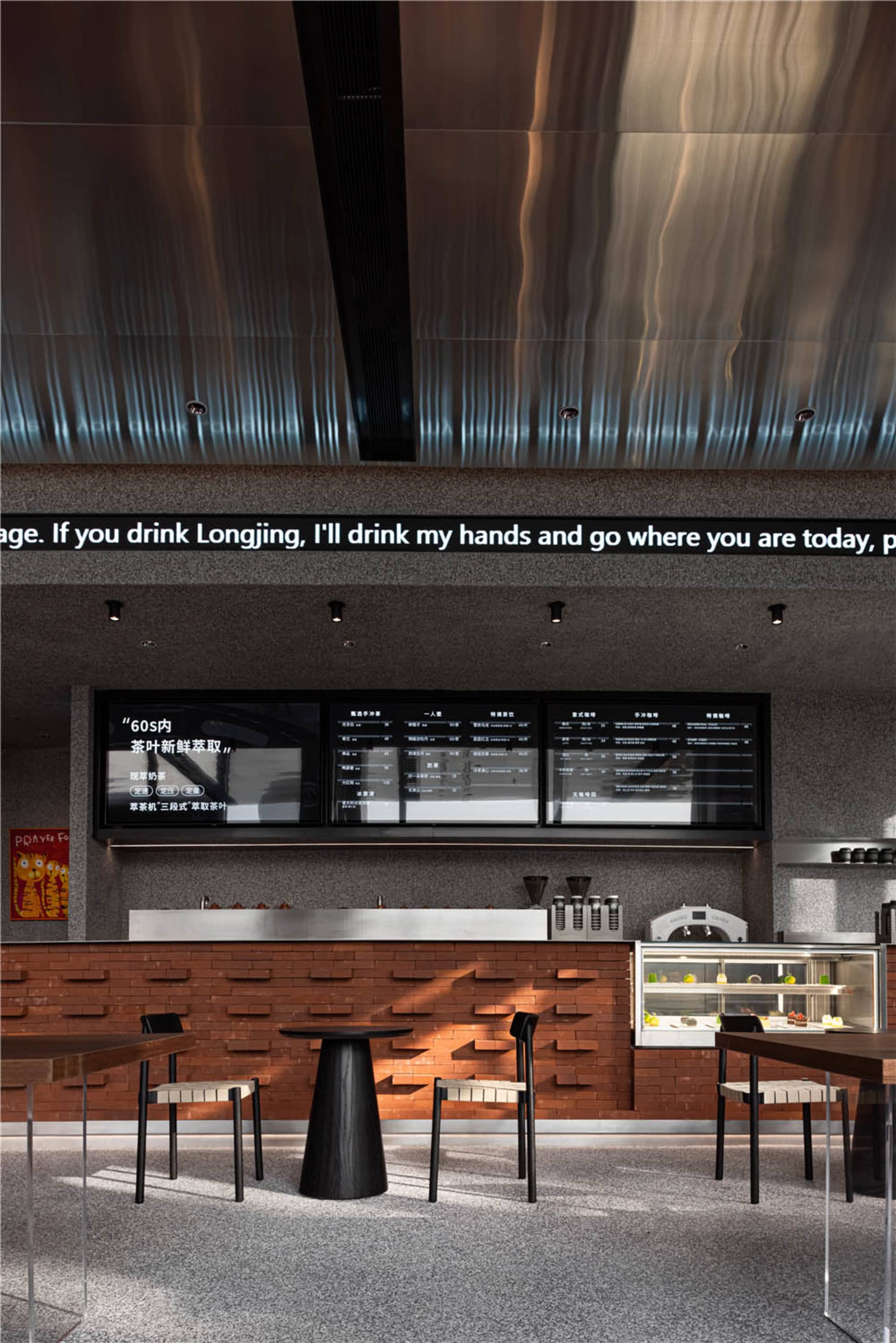 Modern restaurant interior with a bar counter, stools, dining tables, and chairs, featuring cups on surfaces and a welcoming atmosphere