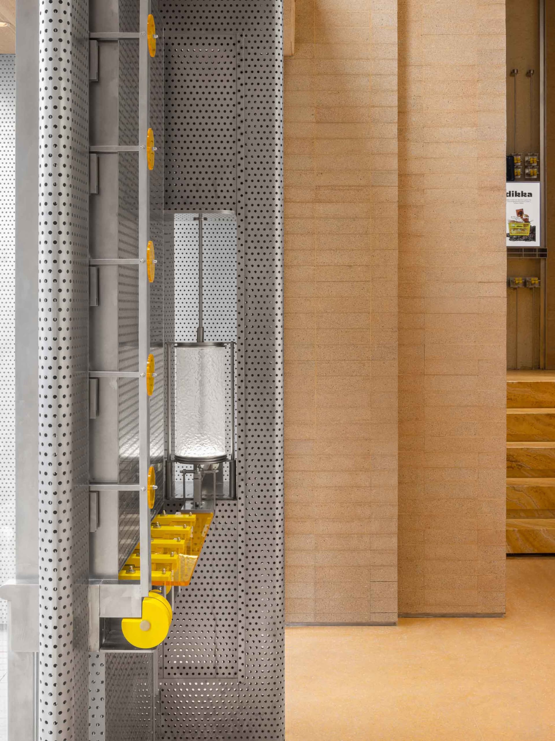 Wooden room with a metal panel featuring yellow dots and a mounted mirror adding depth and interest
