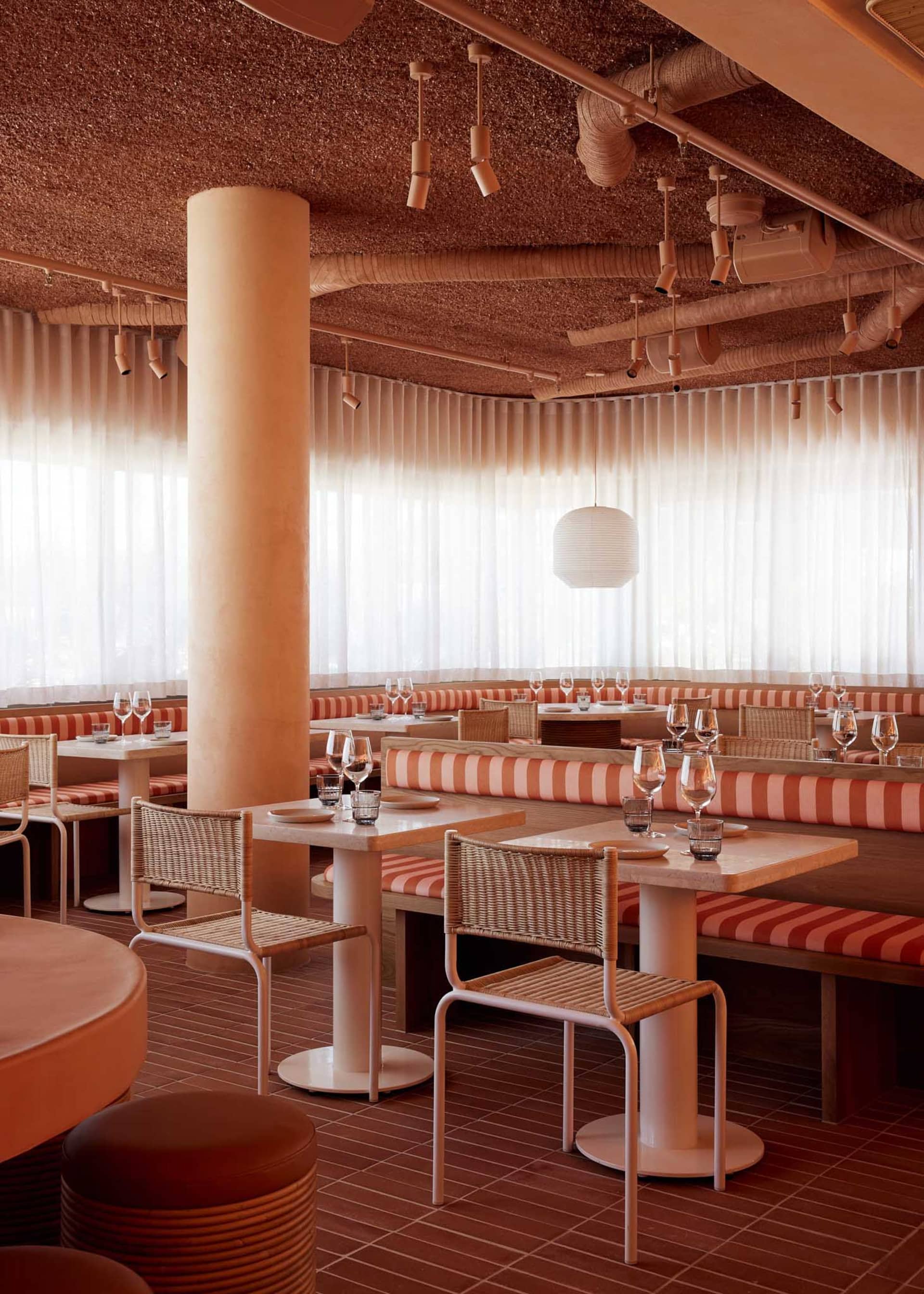 elegant dining space with wooden tables and chairs, wine glasses, and a comfortable atmosphere