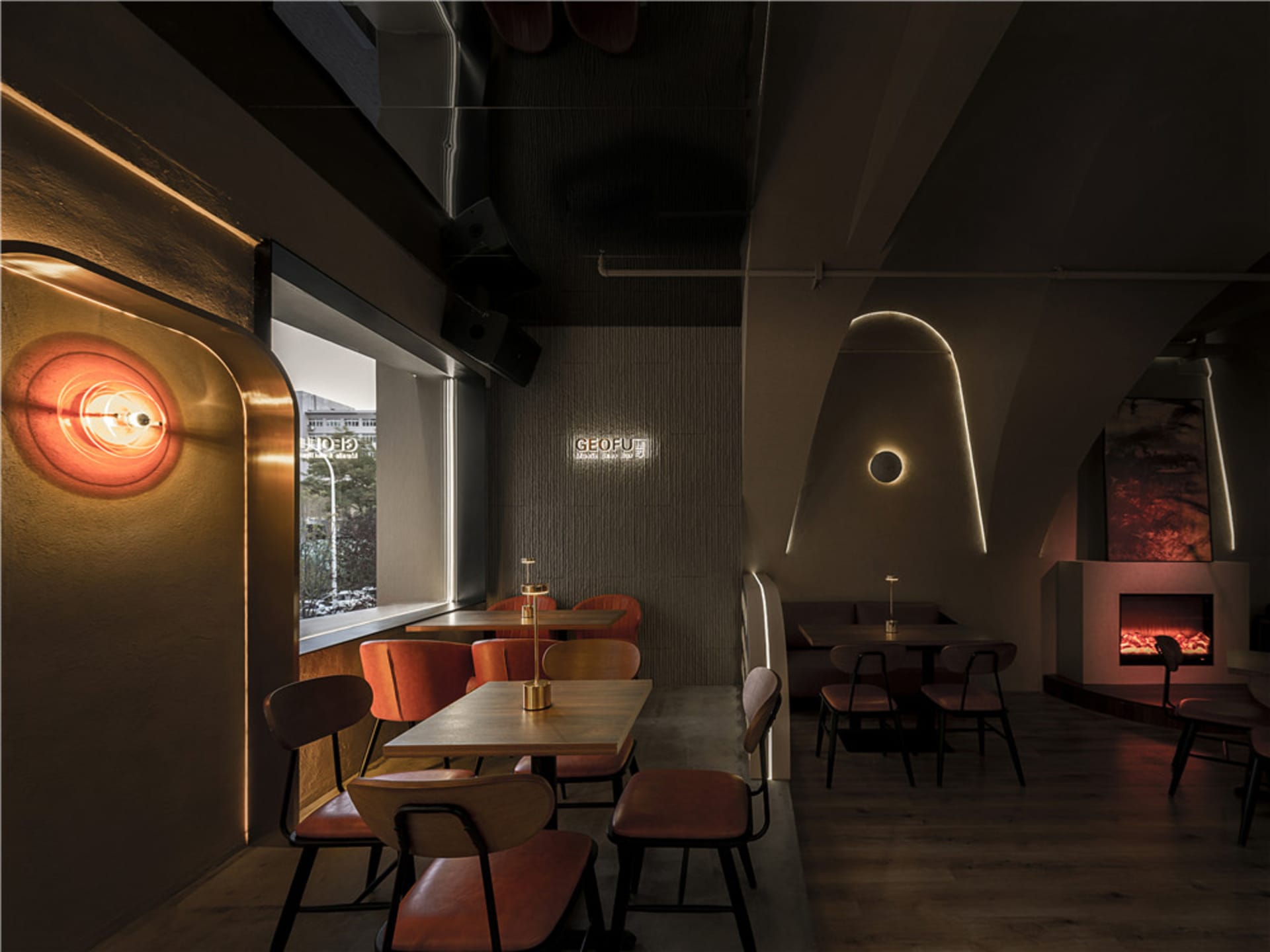 Cozy restaurant interior with multiple tables, chairs, and couches, perfect for dining and socializing